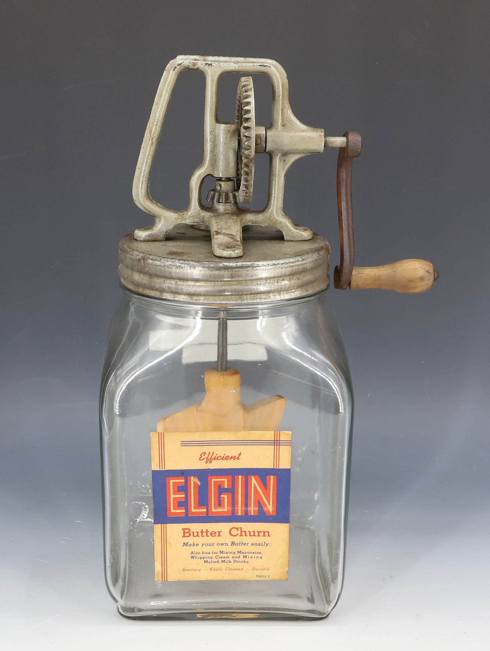 ELGIN GLASS BUTTER CHURN: ORIGINAL PAPER LABEL. GLASS, TIN AND IRON. 13 3/4" H. PLEASE READ CAREFULLY - Terms for Purchasing and Shipping of Auction Items. Please read carefully before bidding. Hartzell?s Auction Gallery. Hart