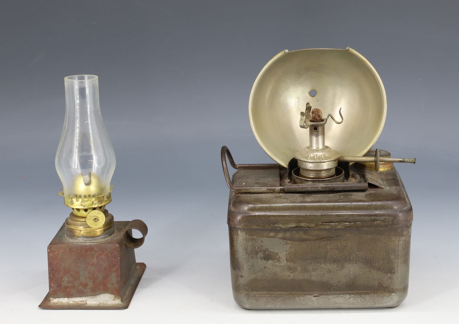 (2) TIN LANTERNS: SMALL SQUARE LANTERN 5 3/4" H. AND RECTANGULAR LANTERN WITH METAL REFLECTOR. FONT IS MRKD. LBF. 4 1/2" L. PLEASE READ CAREFULLY - Terms for Purchasing and Shipping of Auction Items. Please read carefu