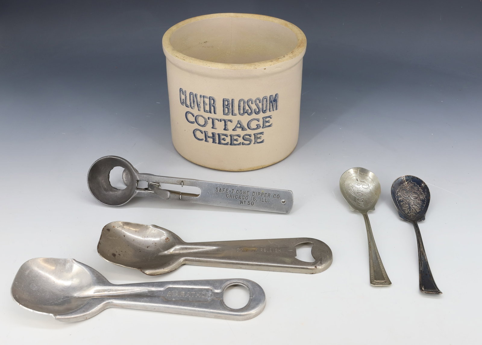 LOT OF DAIRY ADVERTISING ITEMS: INCLUDING: "CLOVER BLOSSOM COTTAGE CHEESE" 4 3/4" X 6". ICE CREAM SCOOPS (ONE MRKD. BANK OF RALEIGH) TWO BREYER'S SPOONS. PLEASE READ CAREFULLY - Terms for Purchasing and Shipping of Auction Items. Pl