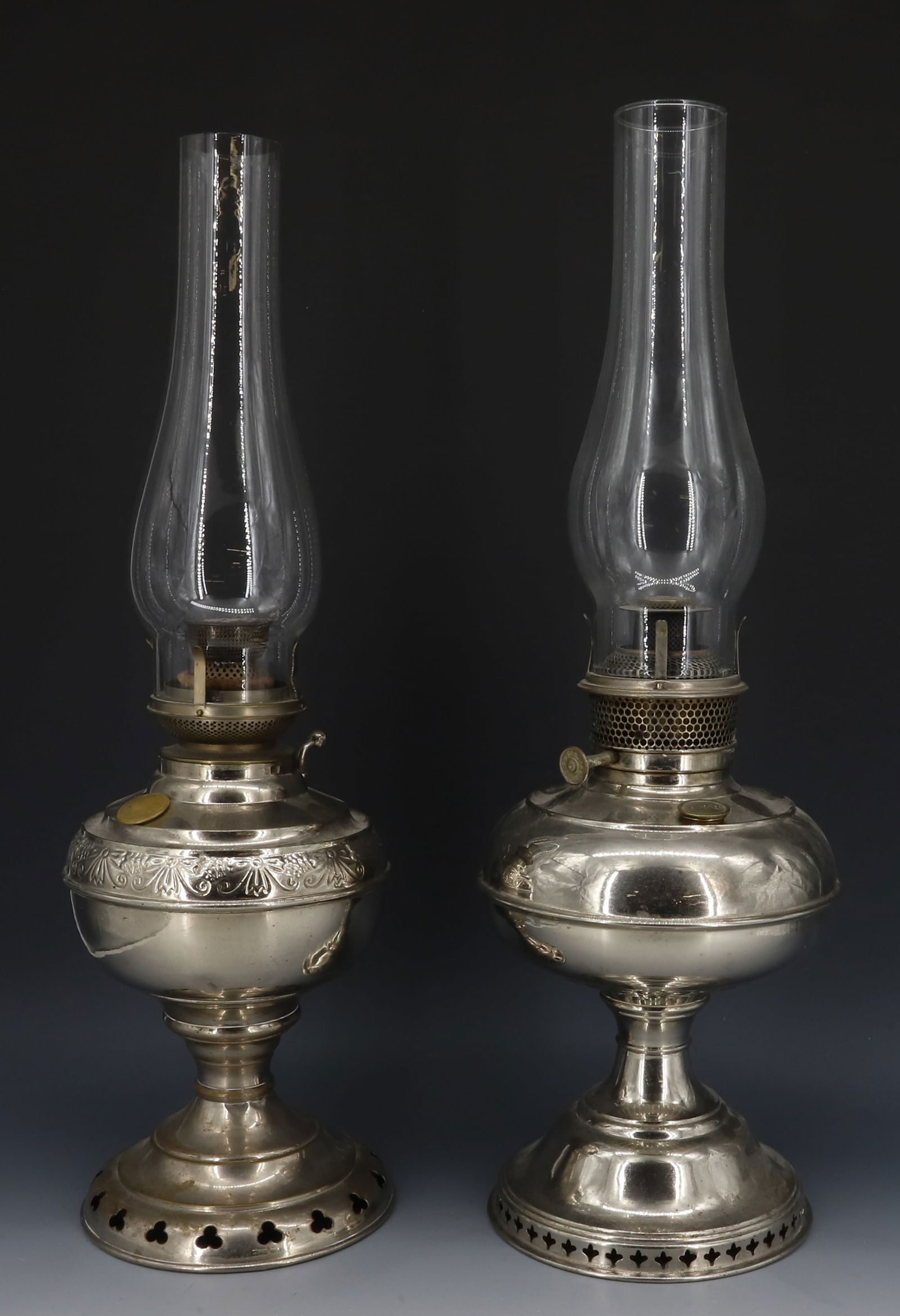 (2) ANTIQUE KEROSENE LIGHTS: NICKEL-PLATED. ONE MRKD. B&H (BRADLEY HUBBARD) AND THE OTHER'S BURNER IS MRKD. NEW AURORA, WISCONSIN. TOTAL HEIGHTS 20 1/4" AND 20 3/4"H. PLEASE READ CAREFULLY - Terms for Purchasing and Shipping of A