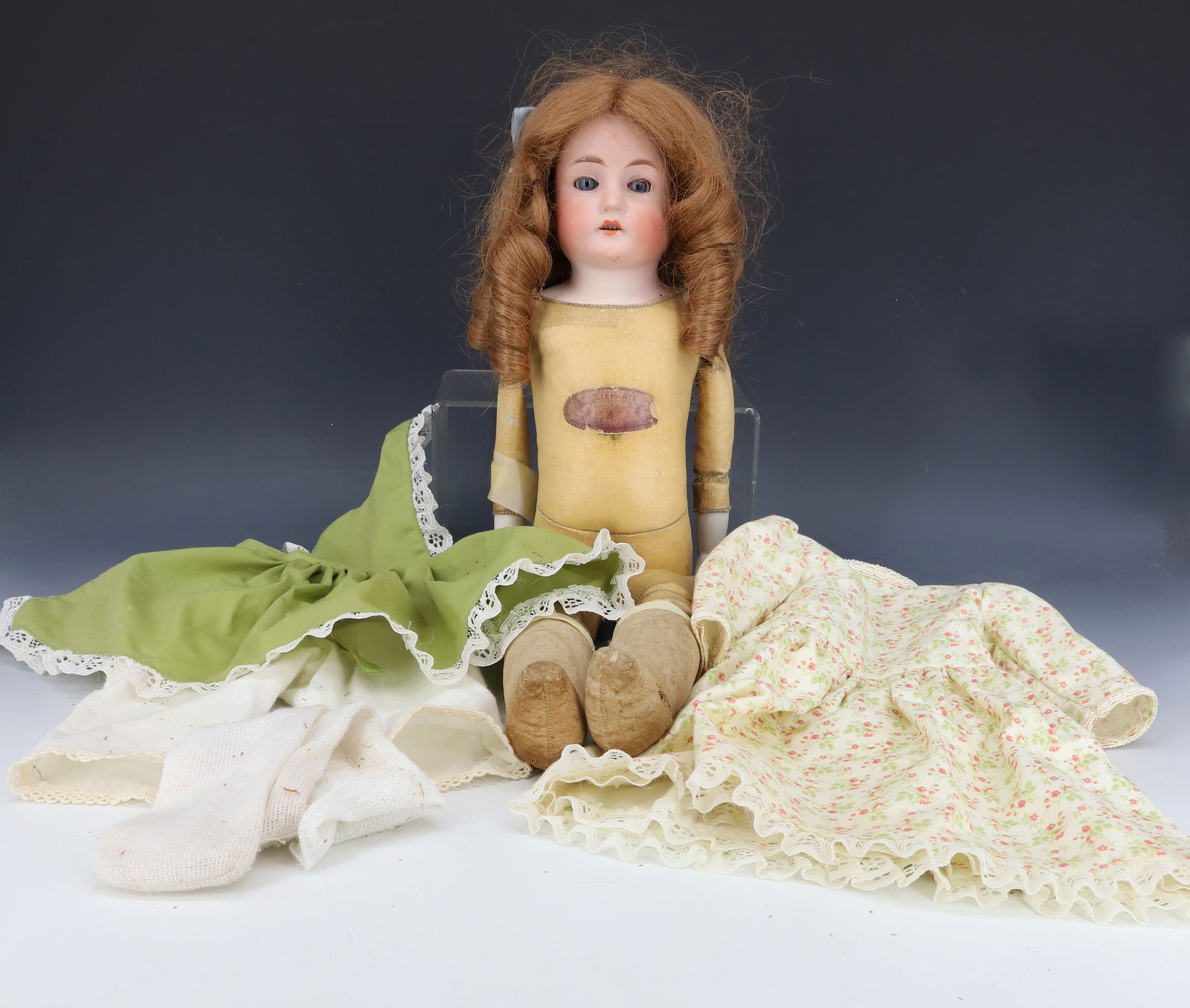 ANTIQUE BISQUE GERMAN DOLL: BISQUE HEAD, OPEN MOUTH, LEATHER BODY WITH ORIGINAL LABEL. MRKD. "GERMANY, MABEL, 4/O" ON BACK. 18" L. PLEASE READ CAREFULLY - Terms for Purchasing and Shipping of Auction Items. Please read carefully