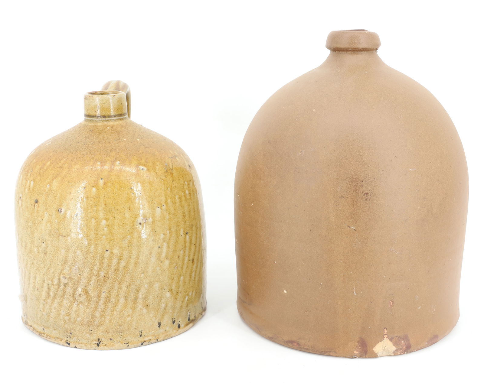 (2) STONEWARE JUGS: POTTERY JUGS WITH APPLIED HANDLES. SMALLER HAS DRIPPY EXTERIOR GLAZE 9" H. LARGER IS UNGLAZED AND HEAVY 11 1/2" H. PLEASE READ CAREFULLY - Terms for Purchasing and Shipping of Auction Items. Please re