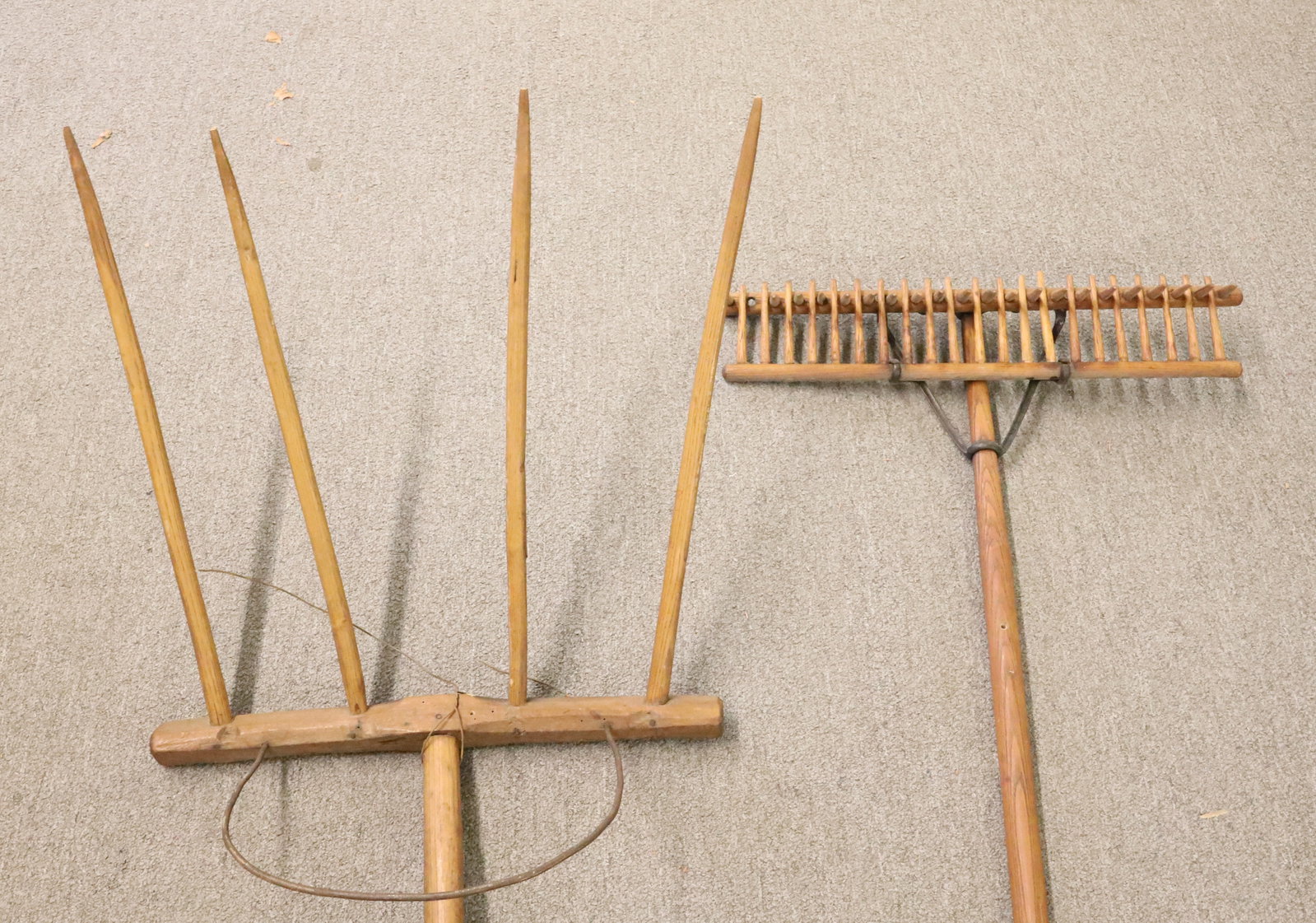 WOODEN HAY FORK AND RAKE: FOUR-PRONG HAY FORK 67" X 21" WITH, WOODEN RAKE WITH IRON BRACE. PLEASE READ CAREFULLY - Terms for Purchasing and Shipping of Auction Items. Please read carefully before bidding. Hartzell?s Auction Ga