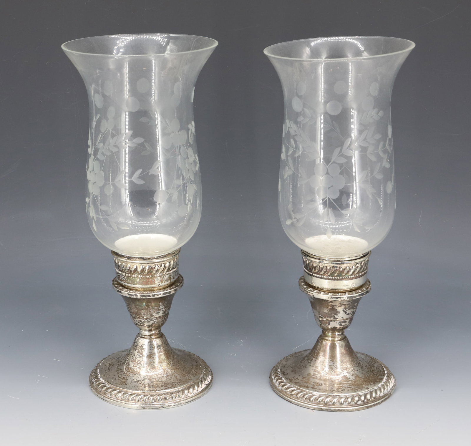 STERLING SILVER HURRICANE CANDLE HOLDERS: WEIGHTED STERLING WITH ENGRAVED SHADES 9 3/4" X 4" PLEASE READ CAREFULLY - Terms for Purchasing and Shipping of Auction Items. Please read carefully before bidding. Hartzell’s Auction Gallery. H
