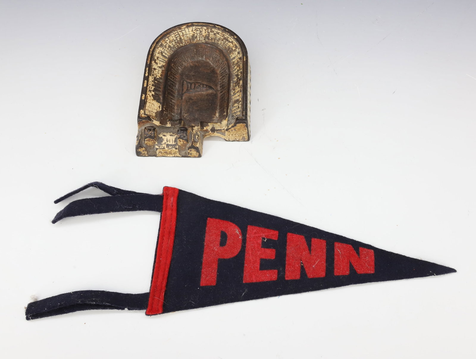 UNIVERSITY OF PENN ASHTRAY AND PENNANT: CAST IRON ASHTRAY WITH "U OF P" PENNANT IN CENTER. WITH, MINIATURE FELT "PENN" PENNANT 8 3/4" L. PLEASE READ CAREFULLY - Terms for Purchasing and Shipping of Auction Items. Please read carefully befor