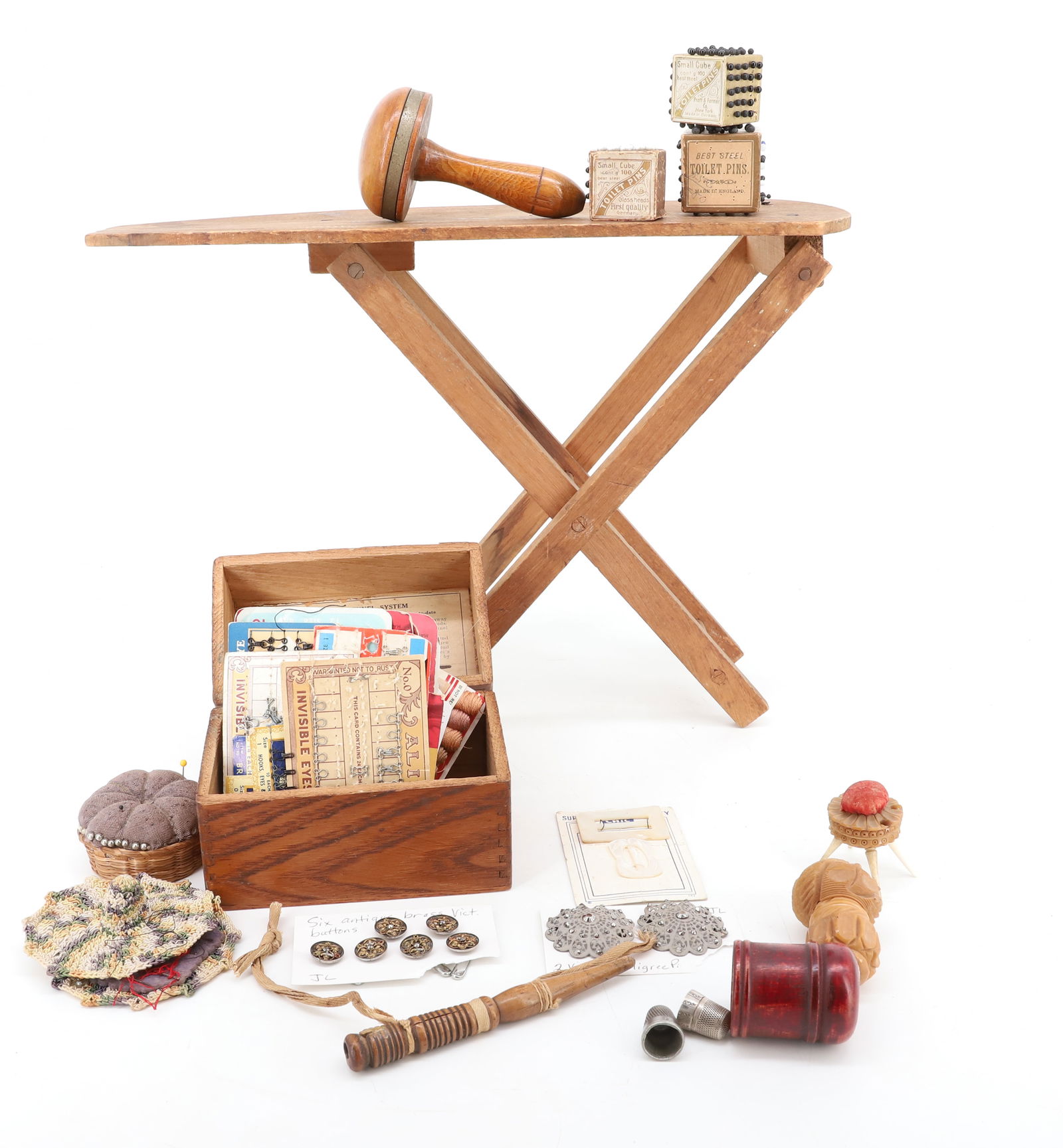 LOT OF SEWING RELATED ITEMS: INCLUDING: DARNER, THIMBLES, PINS, PINCUSHION, BUTTONS, FASTENERS AND MORE. PLUS, CHILD'S WOODEN IRONING BOARD 15 3/4" L. PLEASE READ CAREFULLY - Terms for Purchasing and Shipping of Auction Items. Pl
