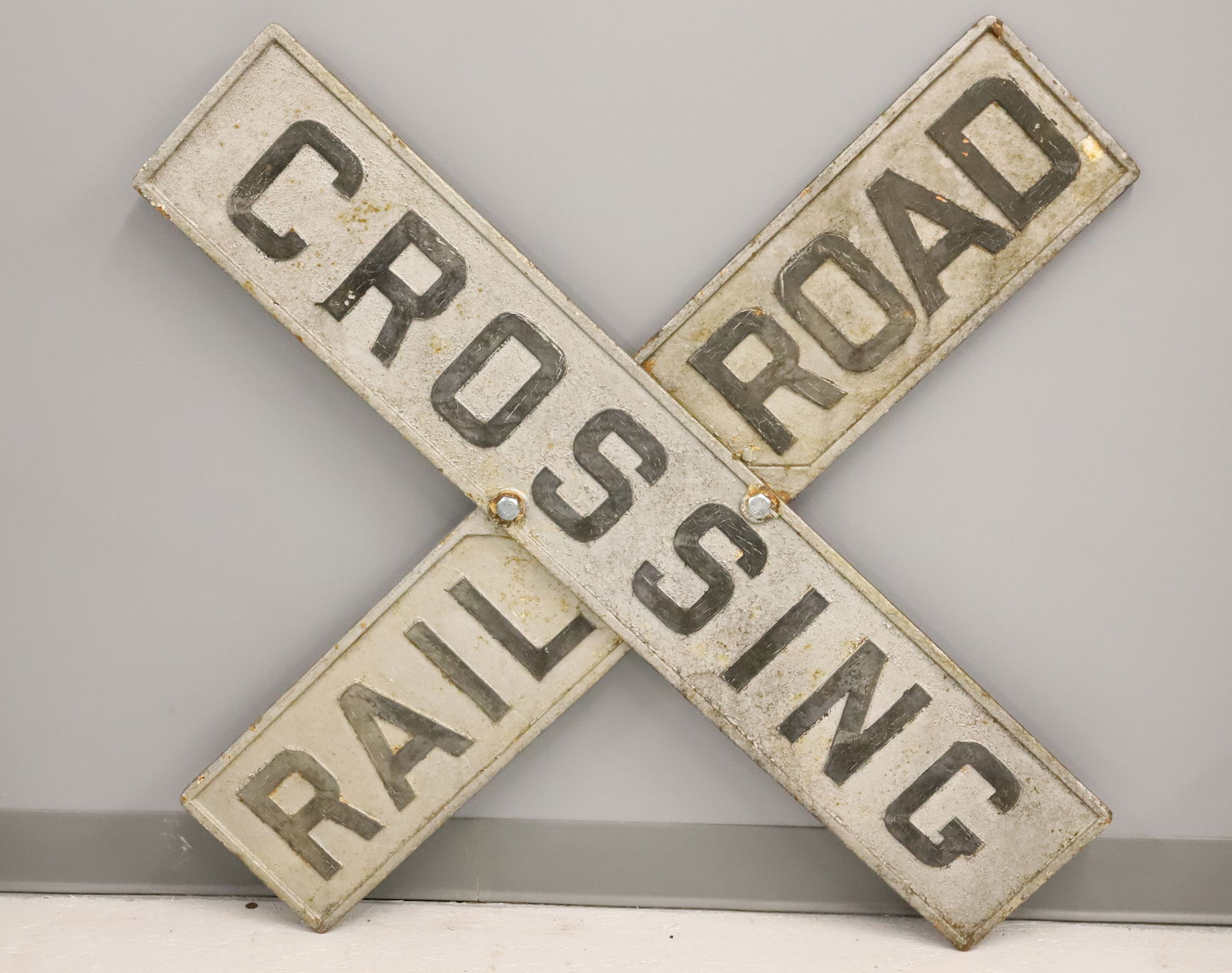 PAINTED CAST IRON RAILROAD CROSSING SIGN: HEAVY CAST IRON PAINTED SILVER AND BLACK. 48" X 48". PLEASE READ CAREFULLY - Terms for Purchasing and Shipping of Auction Items. Please read carefully before bidding. Hartzell’s Auction Gallery.
