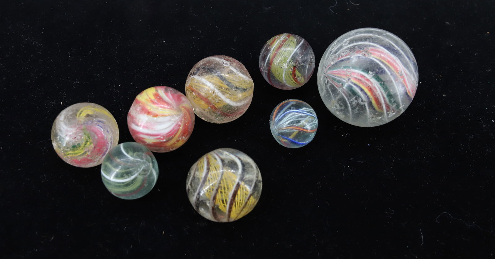 LOT OF VINTAGE GLASS SWIRL MARBLES: VARIOUS SIZES AND SWIRL COLORS. 3/4" TO 1 3/4" DIAMETERS. PLEASE READ CAREFULLY - Terms for Purchasing and Shipping of Auction Items. Please read carefully before bidding. Hartzell’s Auction Gal