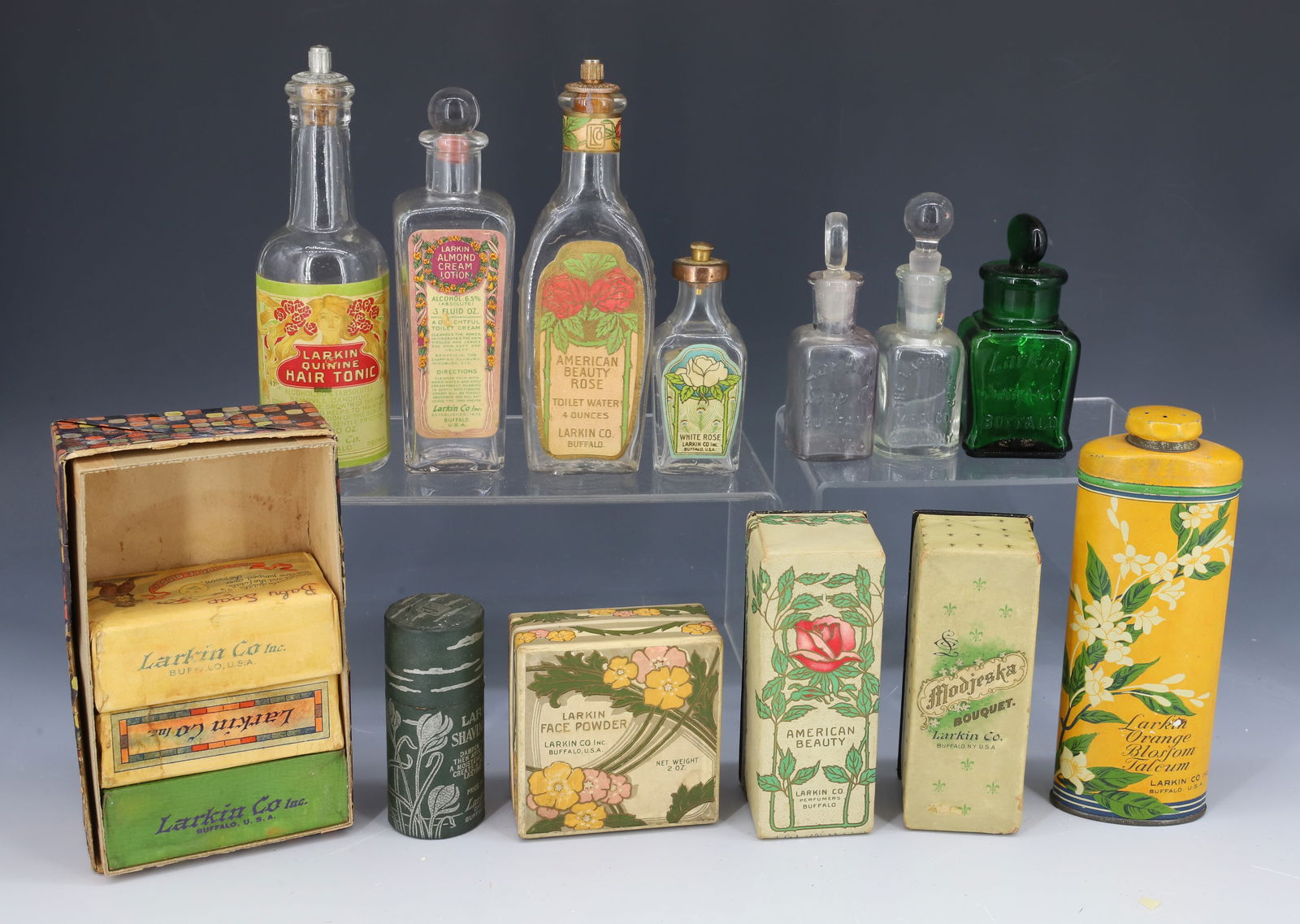 LOT OF VINTAGE LARKIN COMPANY PRODUCTS: GLASS PERFUME BOTTLES WITH ORIGINAL PAPER LABELS, PRINTED BOXES AND TALCUM TINS. LARKIN CO. BRAND LARGEST 6 1/4" H. PLEASE READ CAREFULLY - Terms for Purchasing and Shipping of Auction Items. Please r
