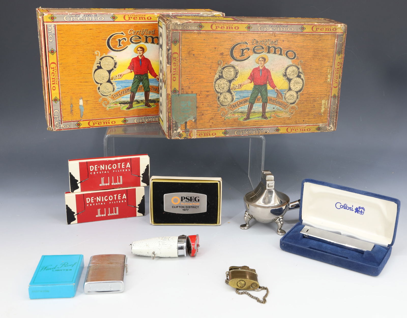 LOT OF VINTAGE LIGHTERS AND CIGAR BOXES: INCLUDING: ASP BRAND WITH WOODEN HANDLE, BRASS LIGHTER W/ CHAIN (JAPAN), COLIBRI IN BOX, ALFRED DUNHILL CRYSTAL FILTERS, TWO CREMO CIGAR BOXES AND MORE. PLEASE READ CAREFULLY - Terms for Purchasing an