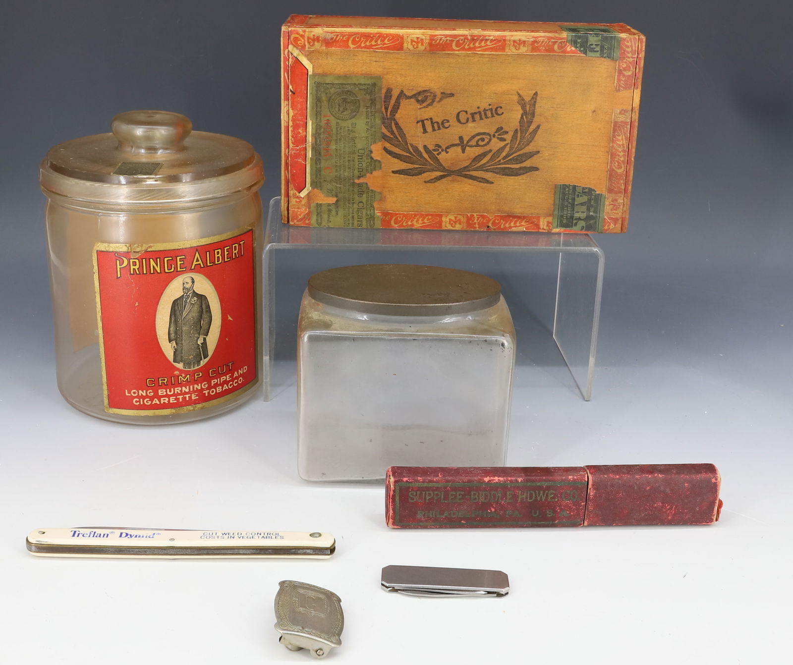 TOBACCO JARS, STRAIGHT RAZOR AND MORE: GLASS PRINCE ALBERT JAR W/LID 6 3/4" H., "THE CRITIC" TOBACCO BOX, LIGGET & MYERS TOBACCO JAR WITH TIN LID, NICKEL SILVER MONOGRAMMED BUCKLE, STRAIGHT RAZOR IN BOX AND MORE. PLEASE READ CAREFULLY - Te