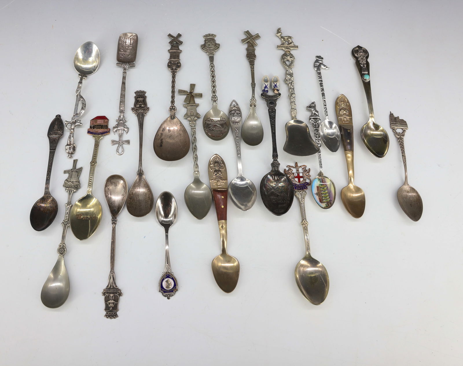 LOT OF SOUVENIR SPOONS: INCLUDING: HOLLAND, BERLIN (ENAMEL BOWL), LONDON, SPAIN, GRAND CANYON, AND MORE. ONE MRKD. 800. ONE MRKD "SILVER" WITH TURQUOISE EMBELLISHMENT. NEW YORK SPOON MRKD. STERLING. MEXICO MRKD. 925. PLEASE