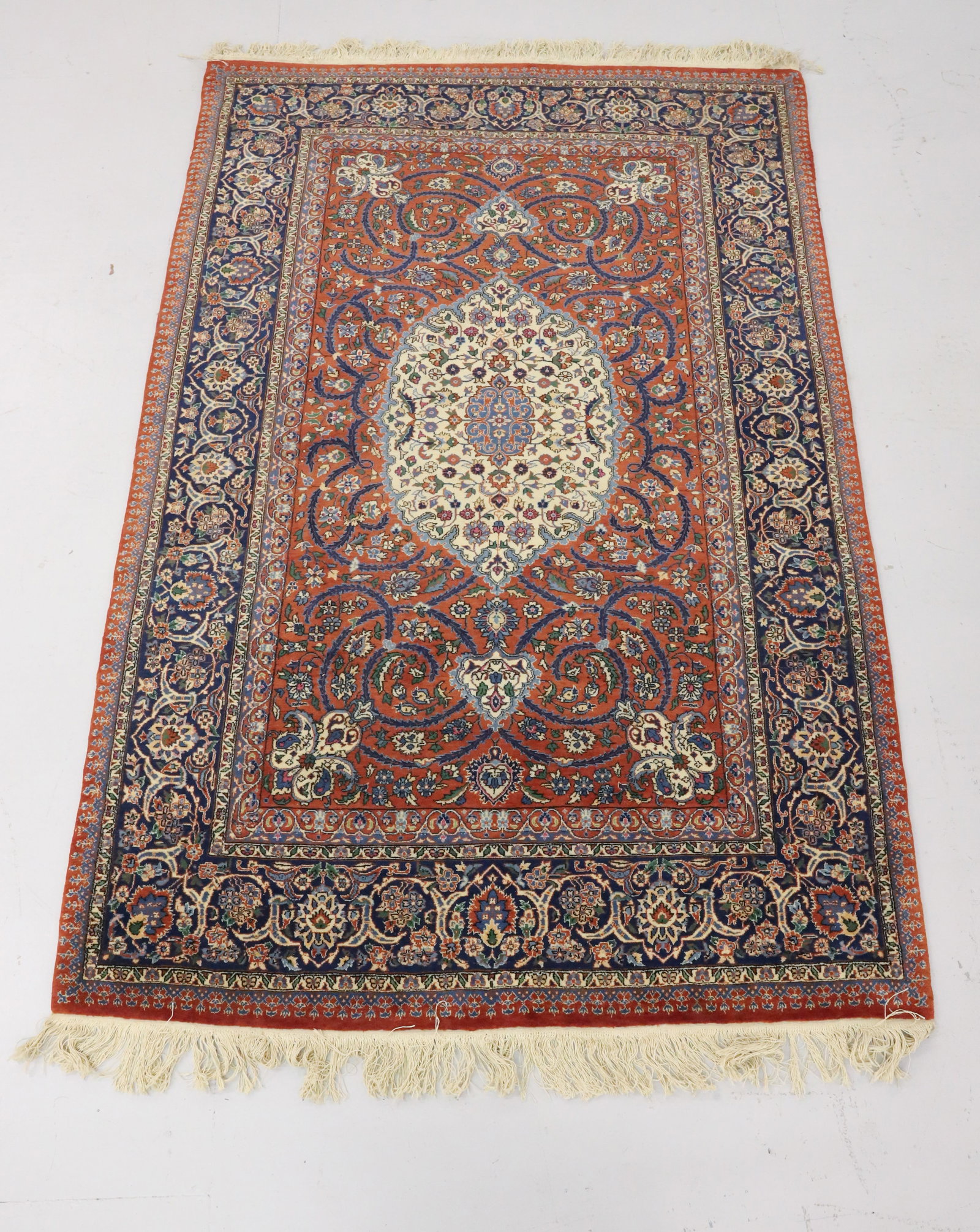 VINTAGE ORIENTAL RUG: ORANGE / BLUE / CREAM /GREEN FLORAL PATTERN WITH CENTRAL MEDALLION. MULTIPLE BORDERS. FRINGE EDGES. 86" X 55". PLEASE READ CAREFULLY - Terms for Purchasing and Shipping of Auction Items. Please read c