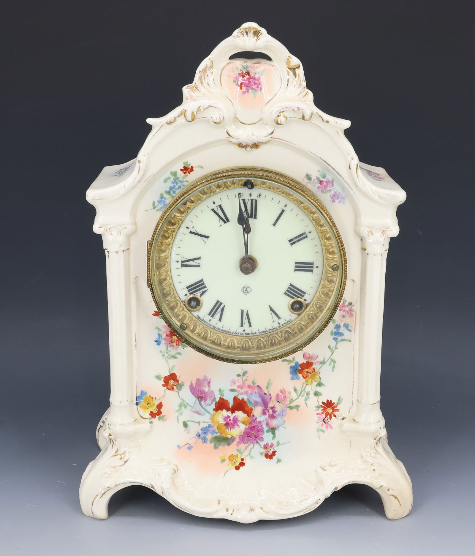 ANSONIA PORCELAIN MANTEL CLOCK: FLORAL DECORATED ROYAL BONN CASE. BRASS WORKS. NO PENDULUM OR KEY. 13" H. PLEASE READ CAREFULLY - Terms for Purchasing and Shipping of Auction Items. Please read carefully before bidding. HartzellR