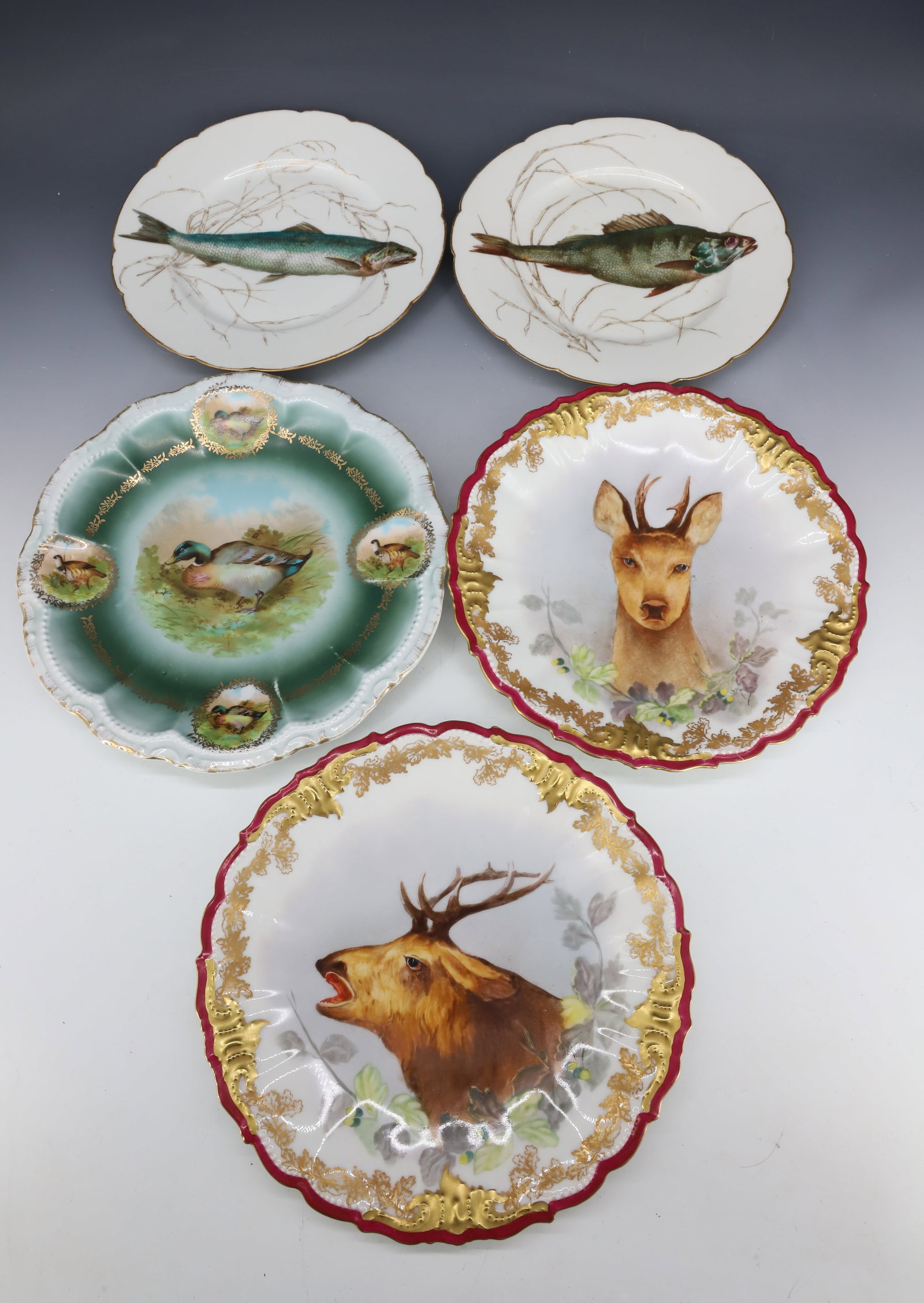LOT OF PORCELAIN ANIMAL GAME PLATES: INCLUDING: TWO FISH MRKD. CFH ON BACK. 9" D. ELK/SPIKE BUCK MRKD. LIMOGES FRANCE ON BACK. 9 1/2" D. SINGLE DUCK/QUAIL PLATE MRKD. BAVARIA. 10" D. PLEASE READ CAREFULLY - Terms for Purchasing and Shipp