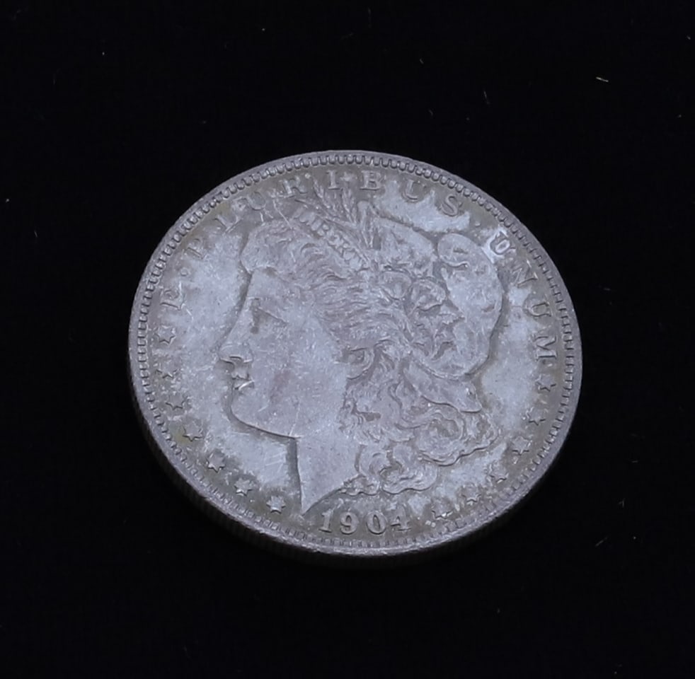 1904 O MORGAN DOLLAR: 1904 0 MORGAN DOLLAR PLEASE READ CAREFULLY - SINCE THIS IS A COIN SALE PLEASE NOTE. ITEMS MUST BE PAID FOR THROUGH LIVE AUCTIONEERS OR WITH CASH OR CHECK IN PERSON - Terms for Purchasing and Shipping 