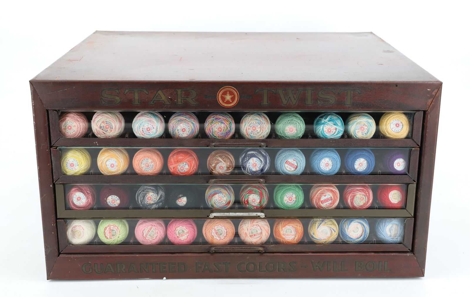 STAR TWIST METAL SPOOL CABINET: FOUR DRAWERS WITH GLASS FRONTS. MRKD. ON FRONT / BACK /SIDES. 8 1/2" X 15 3/4" X 14". PLEASE READ CAREFULLY - Terms for Purchasing and Shipping of Auction Items. Please read carefully before bidding.