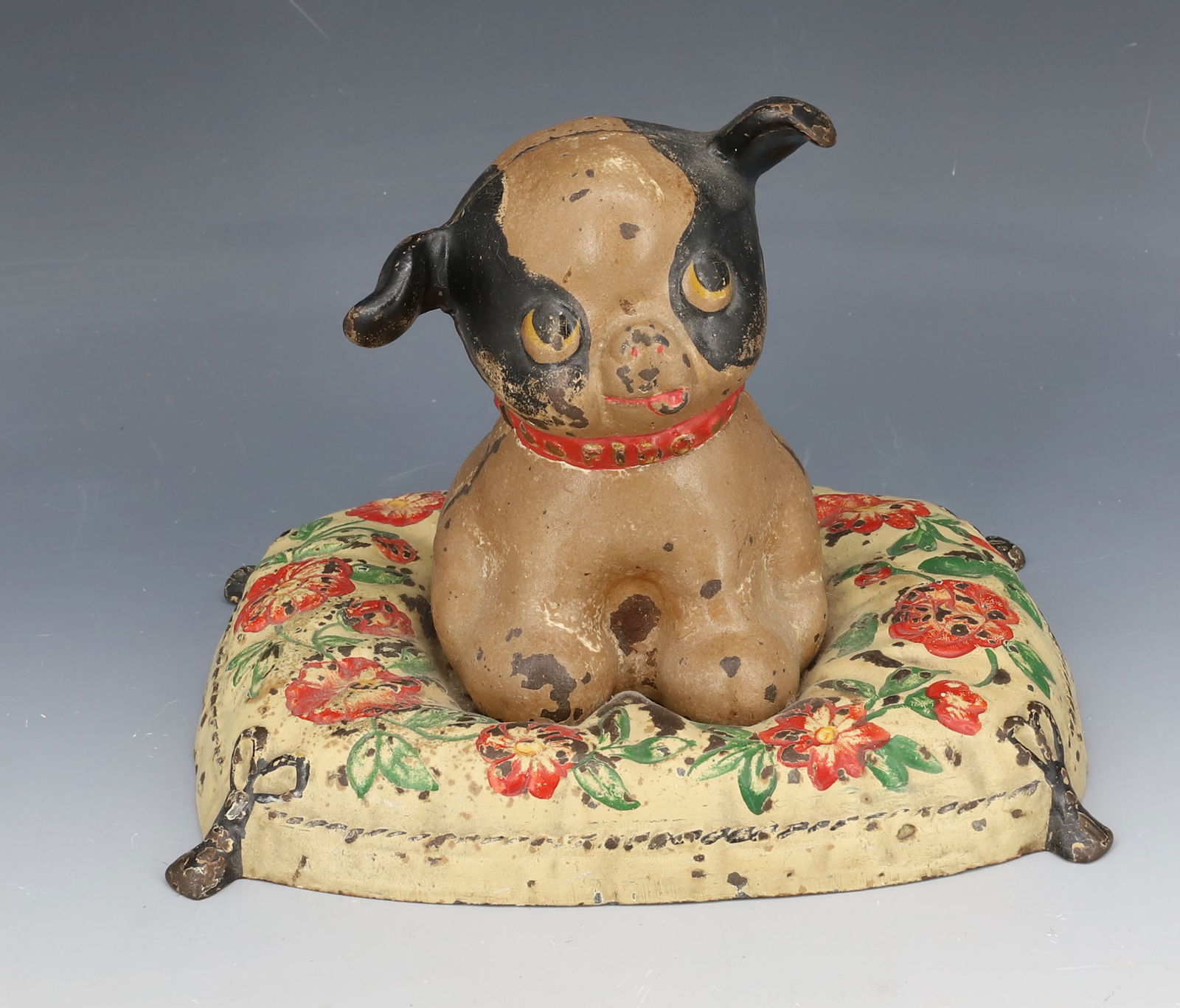 CAST IRON HUBLEY STILL BANK, DOORSTOP: FIDO ON PILLOW PAINTED CAST IRON. 5 1/2" X 7 1/4" X 5 1/2". PLEASE READ CAREFULLY - Terms for Purchasing and Shipping of Auction Items. Please read carefully before bidding. Hartzell’s Auction G