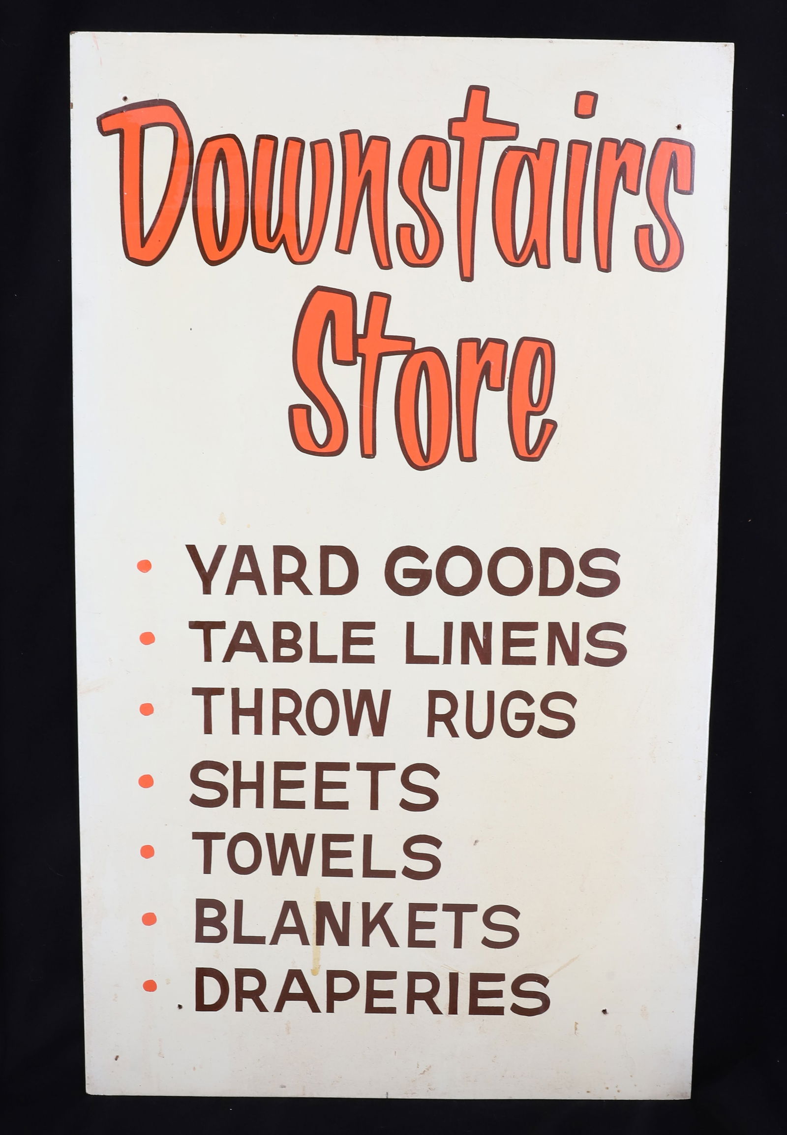 VINTAGE DEPARTMENT STORE SIGN: PAINTED ON MASONITE. "DOWNSTAIRS STORE, YARD GOODS, TABLE LINENS, THROW RUGS, SHEETS, TOWELS, BLANKETS, DRAPERIES" 22" X 13". PLEASE READ CAREFULLY - Terms for Purchasing and Shipping of Auction Items