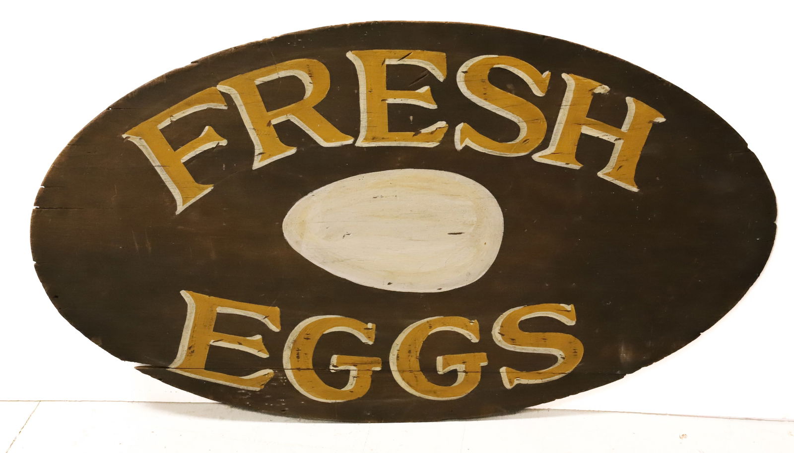 PAINTED "FRESH EGGS" SIGN: OVAL WOODEN SIGN IN YELLOW / WHITE WITH EGG IN CENTER. WOOD HAS BEVELED EDGE NOTICEABLE ON BACK. 17" X 29 1/2". PLEASE READ CAREFULLY - Terms for Purchasing and Shipping of Auction Items. Please read