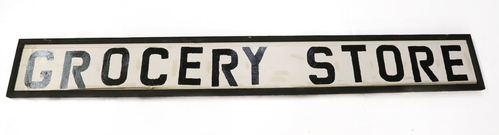 WOODEN "GROCERY STORE" SIGN: BLACK LETTERS ON WHITE WITH BLACK FRAMEWORK. 9" X 70". PLEASE READ CAREFULLY - Terms for Purchasing and Shipping of Auction Items. Please read carefully before bidding. Hartzell’s Auction Galler