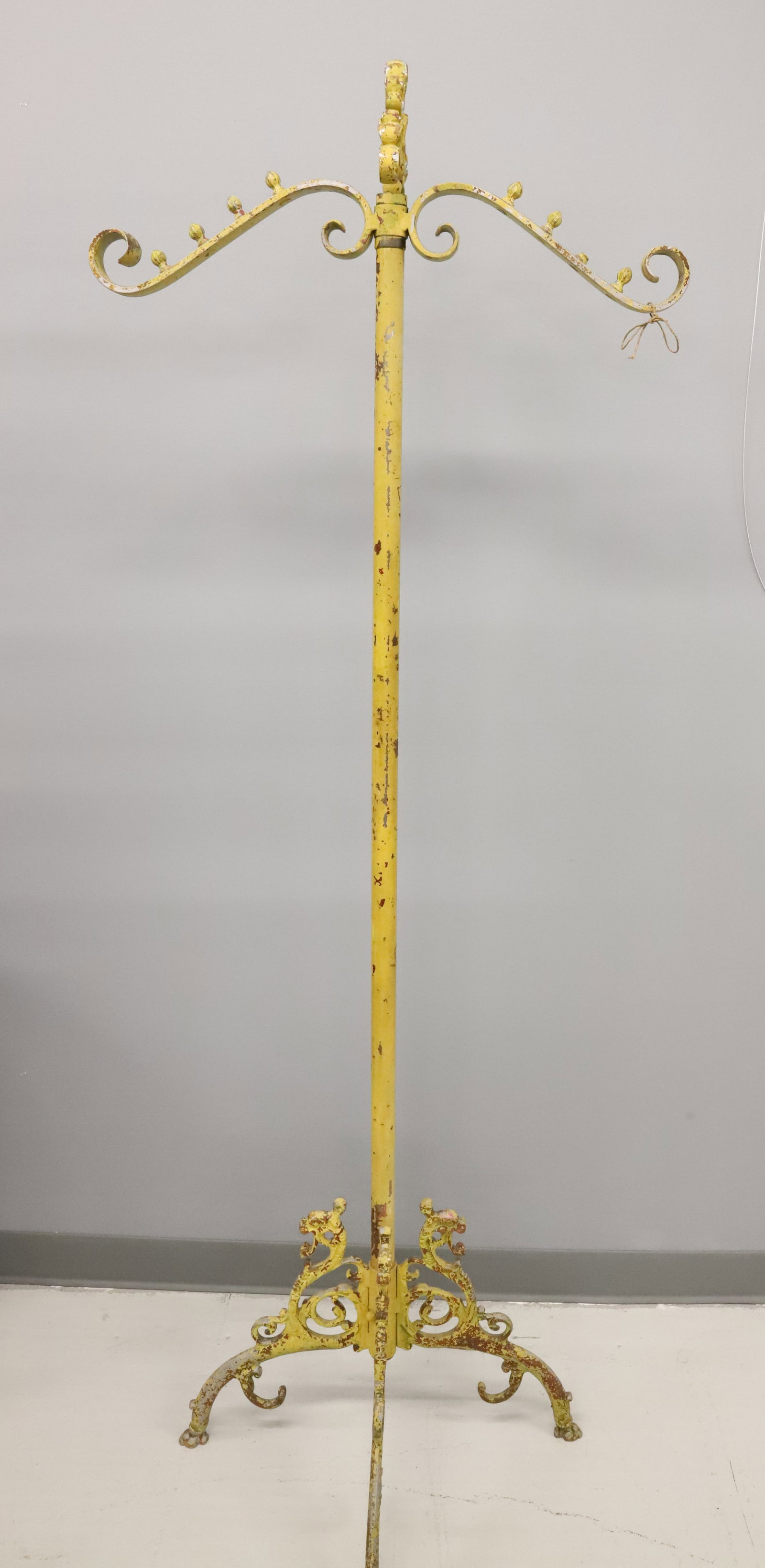 PAINTED METAL STORE FIXTURE / DISPLAY: YELLOW PAINTED ALUMINUM. ART NOUVEAU STYLE. ANIMAL HEADS AT TOP OF LEGS WITH HOOF FEET. 71" X 26 1/2". PLEASE READ CAREFULLY - Terms for Purchasing and Shipping of Auction Items. Please read carefully