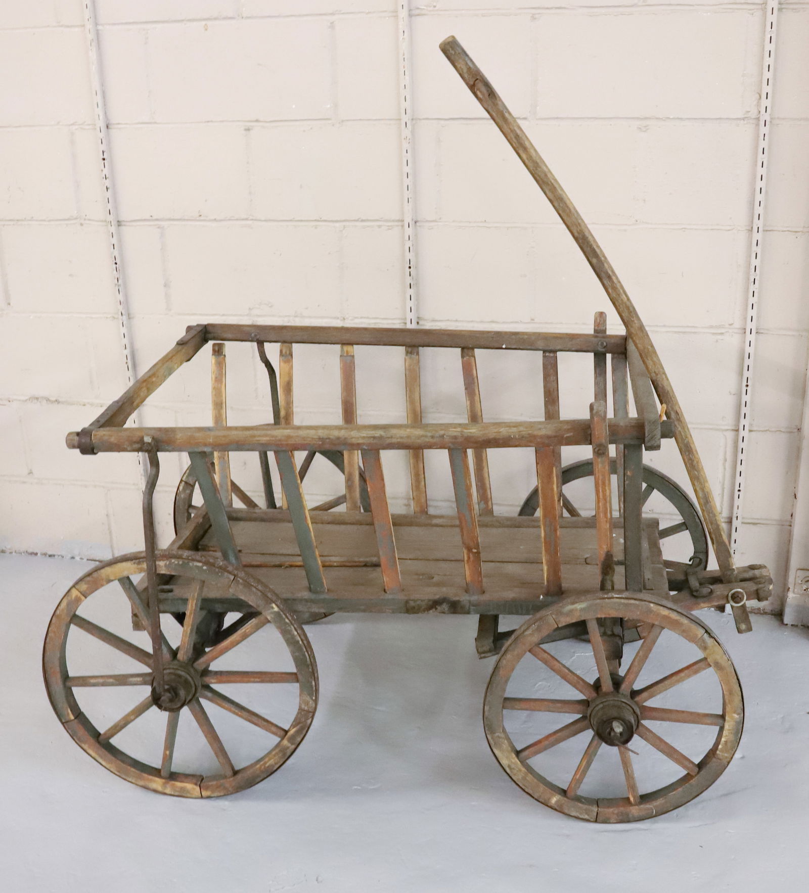 ANTIQUE WOODEN GOAT CART: WOODEN CART WITH IRON FITTINGS. WHEELS TRIMMED IN IRON BANDS. 27" X 36" X 25". PLEASE READ CAREFULLY - Terms for Purchasing and Shipping of Auction Items. Please read carefully before bidding. Hartzel