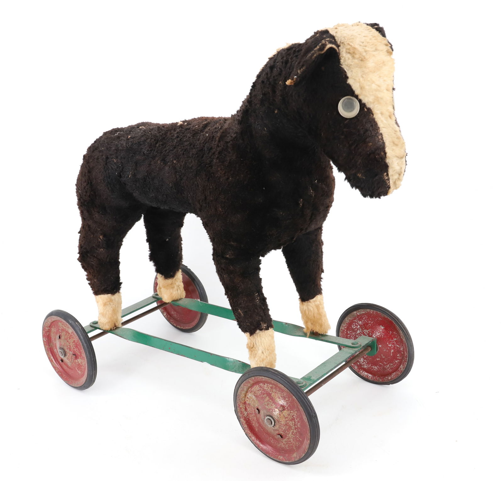 TOY HORSE ON WHEELS: BLACK/ WHITE TEXTILE HORSE ON PAINTED METAL BASE AND WHEELS. 18 1/2" X 20". PLEASE READ CAREFULLY - Terms for Purchasing and Shipping of Auction Items. Please read carefully before bidding. Hartzell&#