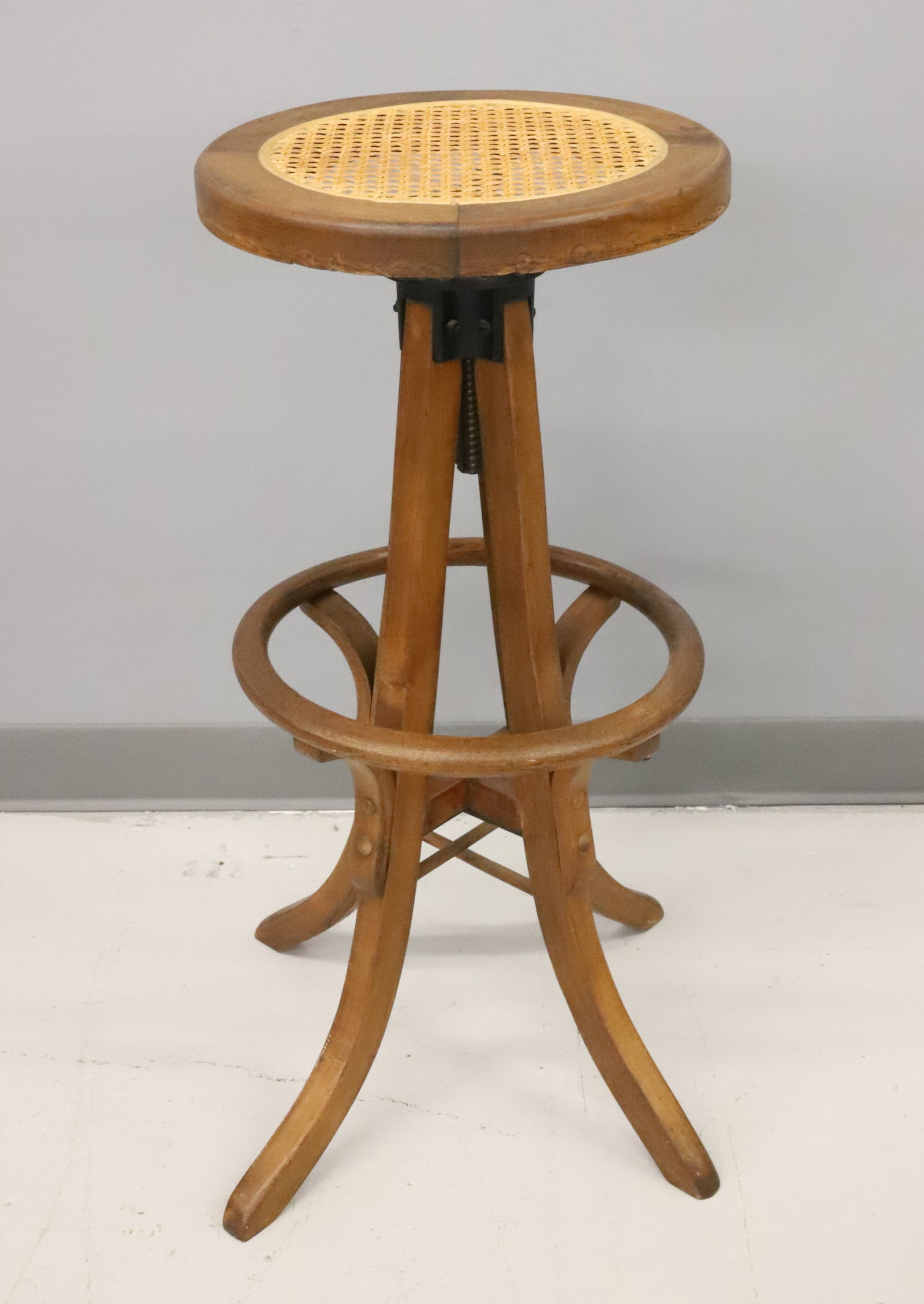 OAK REVOLVING STOOL: CANED SEAT AND FOOTREST. 30" X 14". PLEASE READ CAREFULLY - Terms for Purchasing and Shipping of Auction Items. Please read carefully before bidding. Hartzell’s Auction Gallery. Hartzell's Aucti