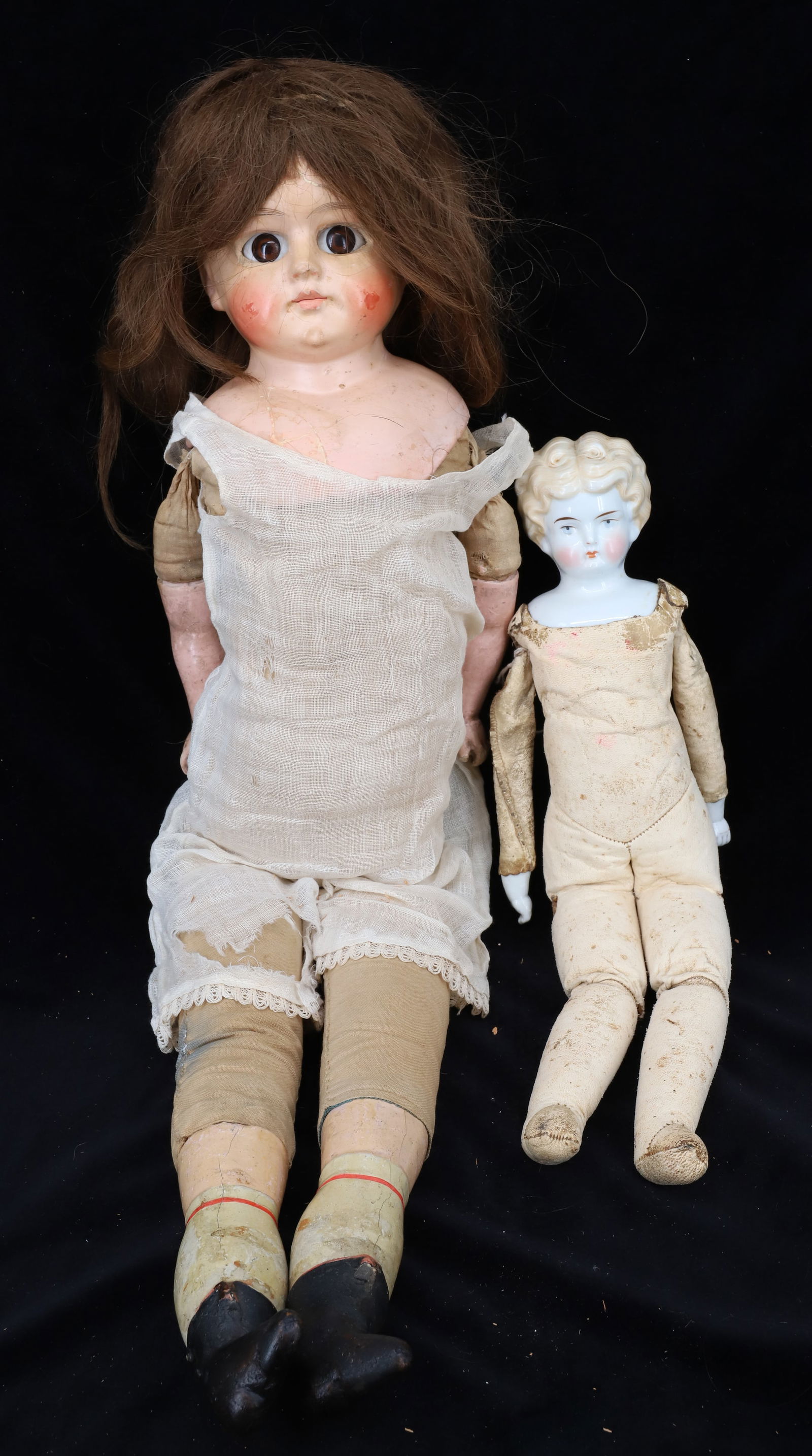 (2) PORCELAIN AND COMPOSITION DOLLS: PORCELAIN HEAD DOLL WITH KID LEATHER BODY PORCELAIN HANDS 14 1/2", COMPOSITION HEAD,LEGS AND ARMS 26" PLEASE READ CAREFULLY - Terms for Purchasing and Shipping of Auction Items. Please read