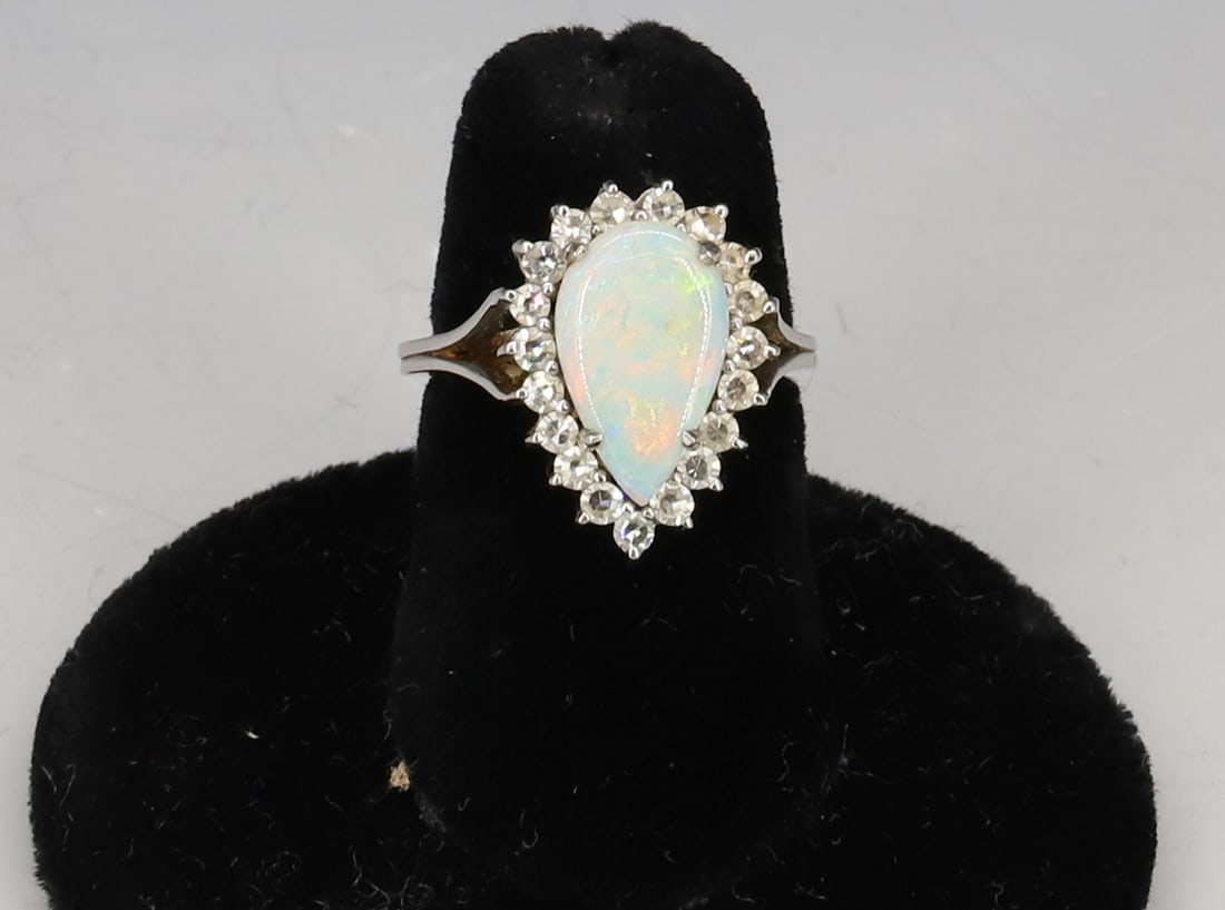 14K WHITE GOLD OPAL/DIAMOND RING: TEARDROP OPAL WITH ROUND DIAMONDS BORDER SIZE 5 3/4 TOTAL WEIGHT 2.65 DWT PLEASE READ CAREFULLY - SINCE THIS IS A COIN SALE PLEASE NOTE. ITEMS MUST BE PAID FOR THROUGH LIVE AUCTIONEERS OR WITH