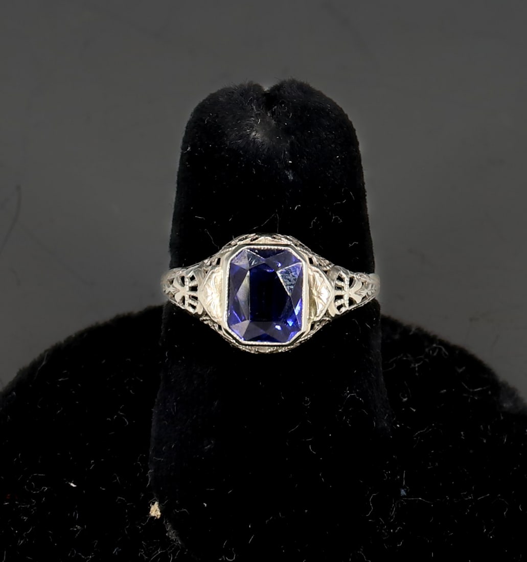 ANTIQUE 10K WHITE GOLD FILIGREE TANZANITE RING: EMERALD CUT TANZANITE 10K WHITE GOLD FILIGREE SIZE 6 TOTAL WEIGHT 1.1 DWT PLEASE READ CAREFULLY - SINCE THIS IS A COIN SALE PLEASE NOTE. ITEMS MUST BE PAID FOR THROUGH LIVE AUCTIONEERS OR WITH