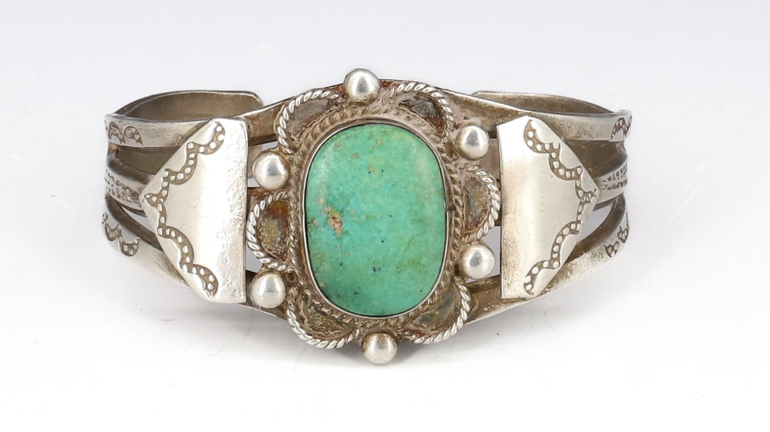 SILVER AND TURQUOISE NATIVE AMERICAN CUFF: GREEN TURQUOISE HAND CHASED 1 3/4" X 2 3/8" TOTAL WEIGHT 1.2 OZT PLEASE READ CAREFULLY - SINCE THIS IS A COIN SALE PLEASE NOTE. ITEMS MUST BE PAID FOR THROUGH LIVE AUCTIONEERS OR WITH CASH OR