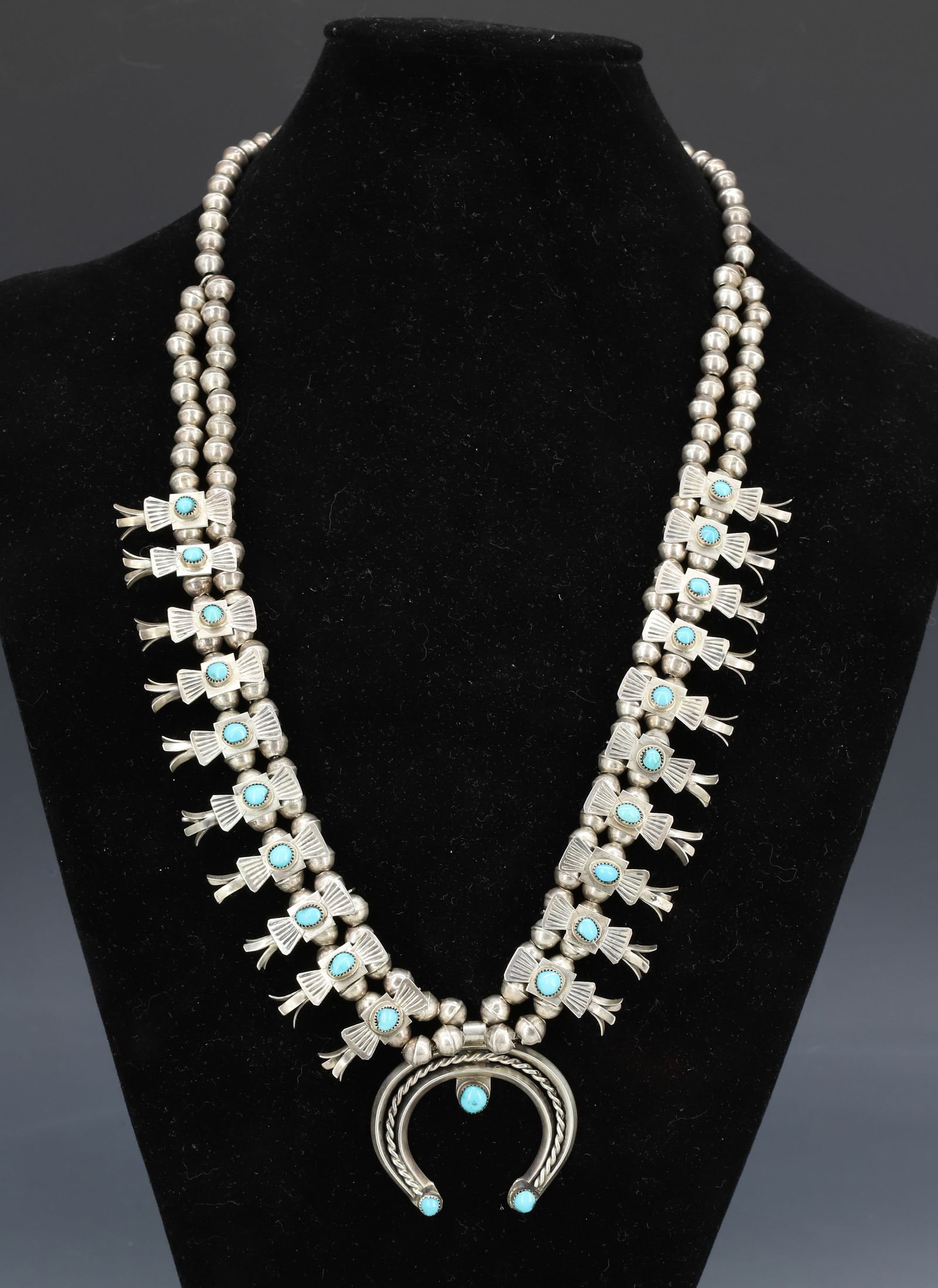 SILVER BOX BOW SQUASH BLOSSOM NECKLACE R. VAZZIE: HAND WROUGHT TWO PIECE BEADS TURQUOISE MARKED R. VAZZIE 24"L TOTAL WEIGHT 3.3 OZT PLEASE READ CAREFULLY - SINCE THIS IS A COIN SALE PLEASE NOTE. ITEMS MUST BE PAID FOR THROUGH LIVE AUCTIONEERS
