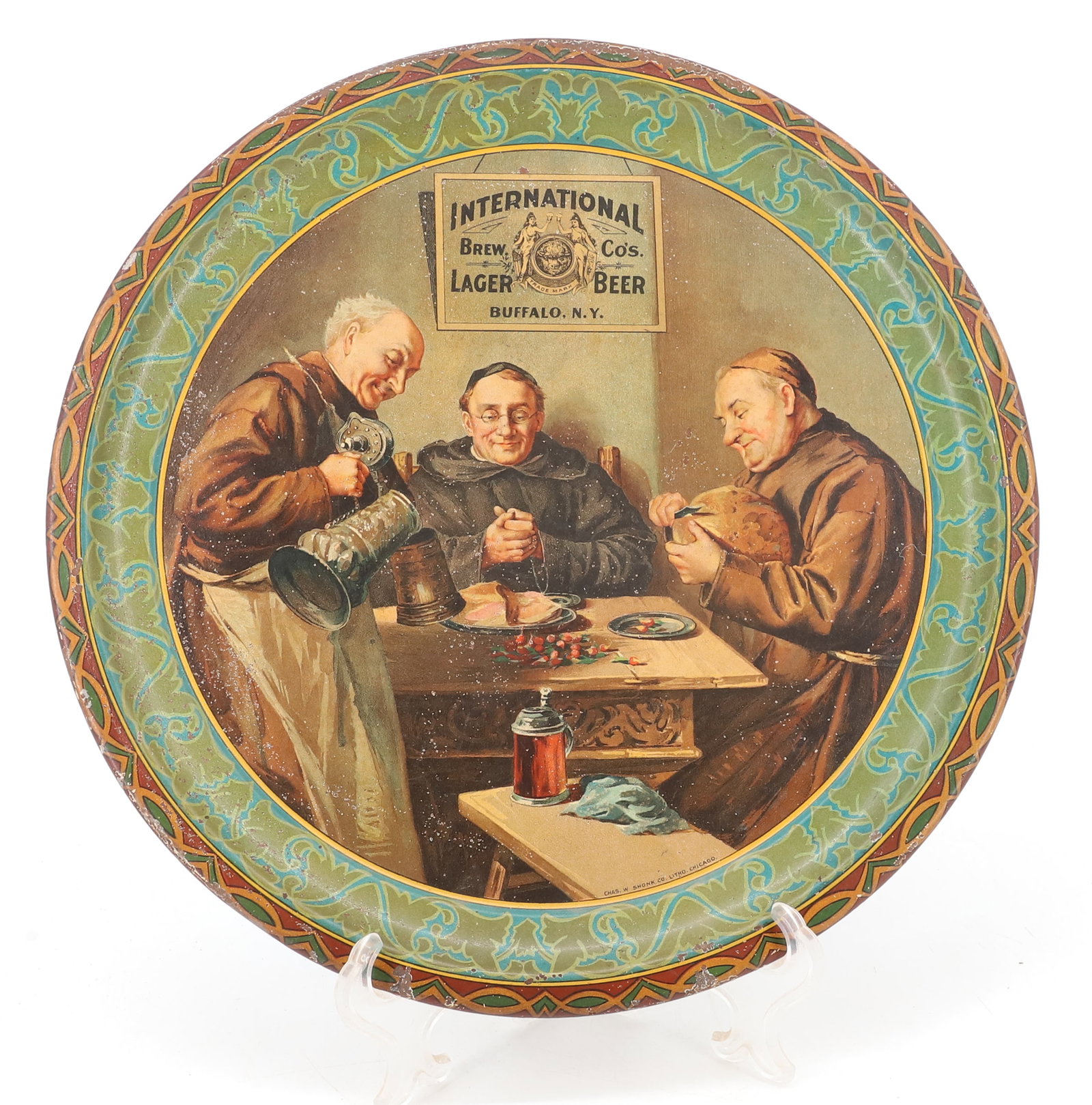 INTERNATIONAL BREW CO.'S BEER TRAY: TIN LITHO TRAY. "LAGER BEER, BUFFALO, N.Y." MRKD. "CHAS. W. SHONK CO. LITHO. CHICAGO". 12 1/8" D. PLEASE READ CAREFULLY - SINCE THIS IS A COIN SALE PLEASE NOTE. ITEMS MUST BE PAID FOR THROUGH LIVE AUC