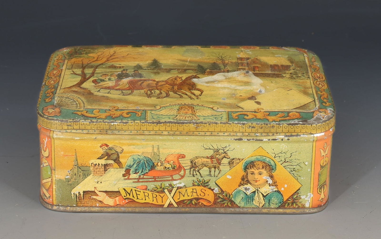 ANTIQUE TIN LITHO SANTA CLAUS / CHRISTMAS TIN: MERRY XMAS AND "SANTA CLAUS IS COMING". HINGED LID. DECORATED ON ALL SIDES. 6" L. PLEASE READ CAREFULLY - SINCE THIS IS A COIN SALE PLEASE NOTE. ITEMS MUST BE PAID FOR THROUGH LIVE AUCTIONEERS OR WITH