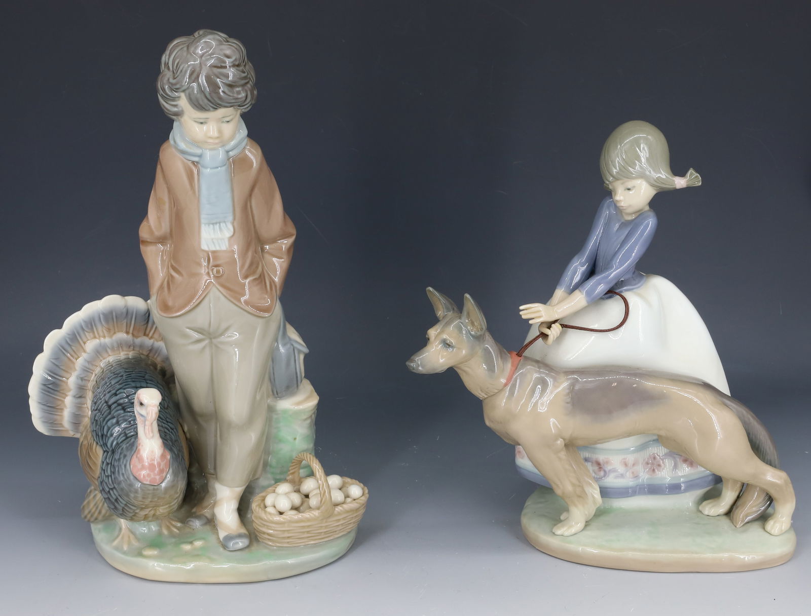 (2) LLADRO FIGURINES: GIRL WITH DOG "NOT SO FAST" 8" H. STANDING BOY WITH EGG BASKET AND TURKEY "BOY WITH TURKEY / CHRISTMAS SELLER" 10 1/8" H. PLEASE READ CAREFULLY - SINCE THIS IS A COIN SALE PLEASE NOTE. ITEMS