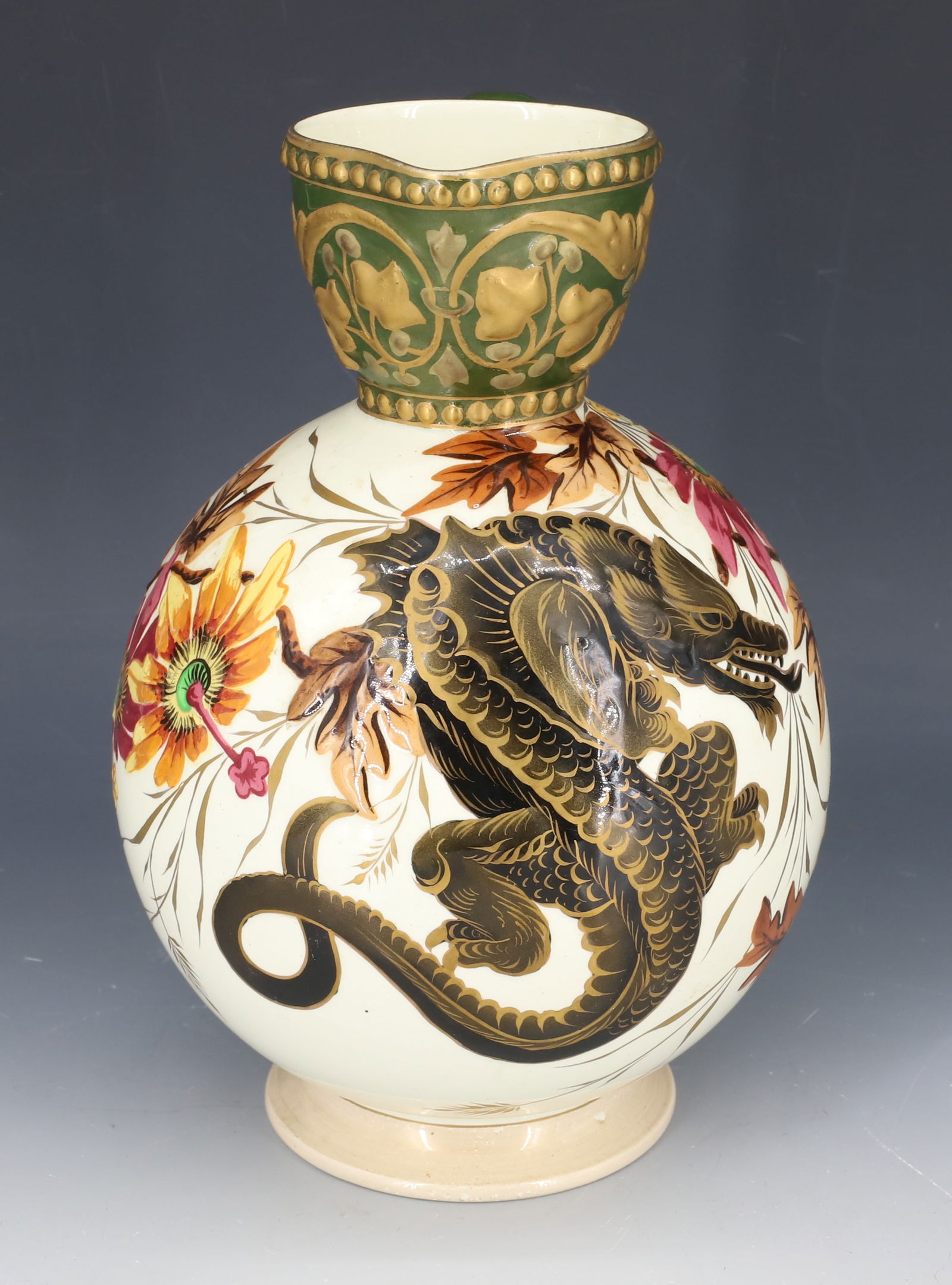 HAND PAINTED RELIEF DECORATED PITCHER: BALL-SHAPE WITH BLACK/GOLD DRAGON ON FRONT WITH FLORAL / LEAF ON EITHER SIDE. MRK. ON BOTTOM. 9" H. PLEASE READ CAREFULLY - SINCE THIS IS A COIN SALE PLEASE NOTE. ITEMS MUST BE PAID FOR THROUGH LIVE A