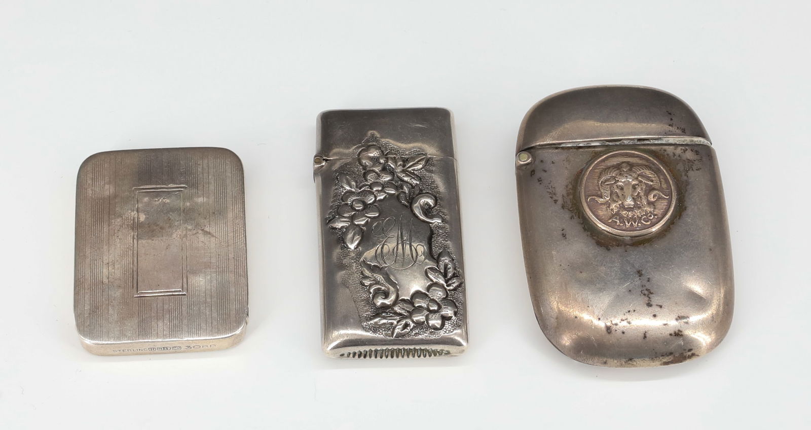 STERLING SILVER MATCH SAFES / PILL BOX: TWO MATCH HOLDERS: LARGER MRKD. "A.W. CO." WITH RAM HEAD ON FRONT 2 1/2" L. (PATENTED JUNE 11, 1918, LIVERMORE & KNIGHT CO. PROV. R.I." WITH VICTORIAN ERA EXAMPLE MONOGRAMMED "E.M." 2 1/4" L. PILL