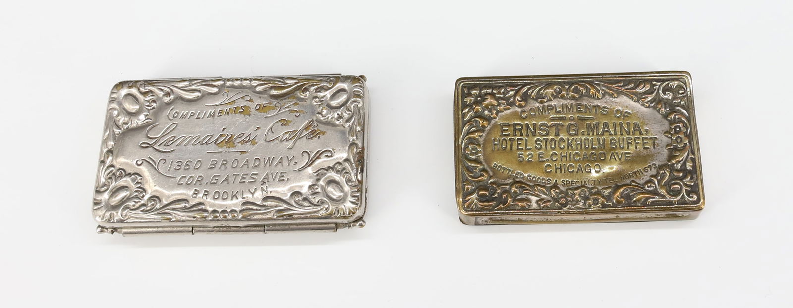 (2) ADVERTISING MATCH SAFES: HINGED EXAMPLE WITH ADMIRAL DEWEY IN RELIEF / "COMPLIMENTS OF LEMAIRE'S CAFE, 1360 BROADWAY...BROOKLYN" 2 3/4" L. WITH, HINGED LID EXAMPLE "COMPLIMENTS OF ERNST G. MAINA, HOTEL STOCKHOLM BUFFET 52 E.
