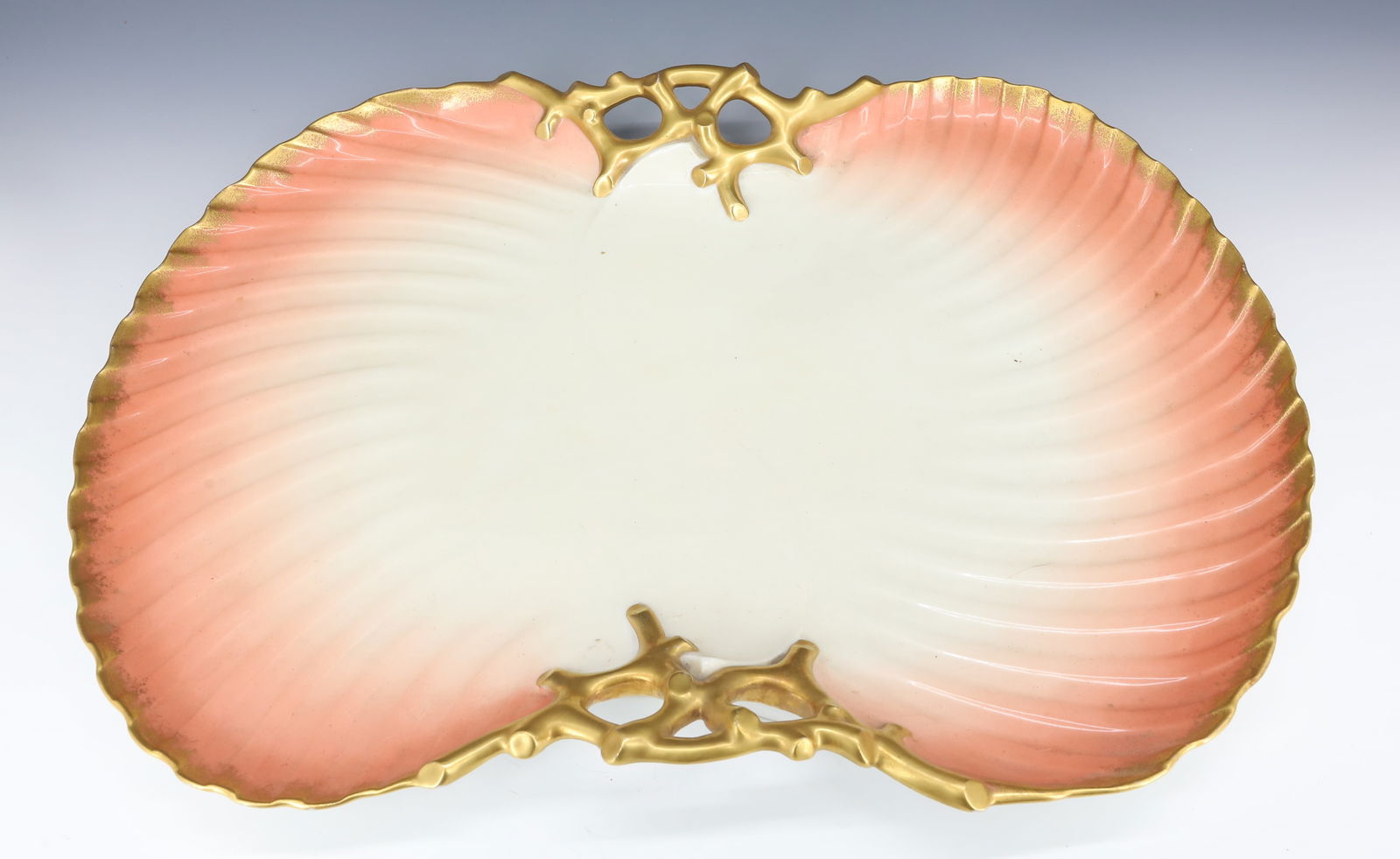 LIMOGES PORCELAIN SERVING TRAY / DISH: MRKD. ON BOTTOM "J. CHAUMETTE, LIMOGES" PINK / WHITE SHELL FORM WITH GOLD TRIM AND CORAL HANDLES. 18 1/4" X 13 1/4".