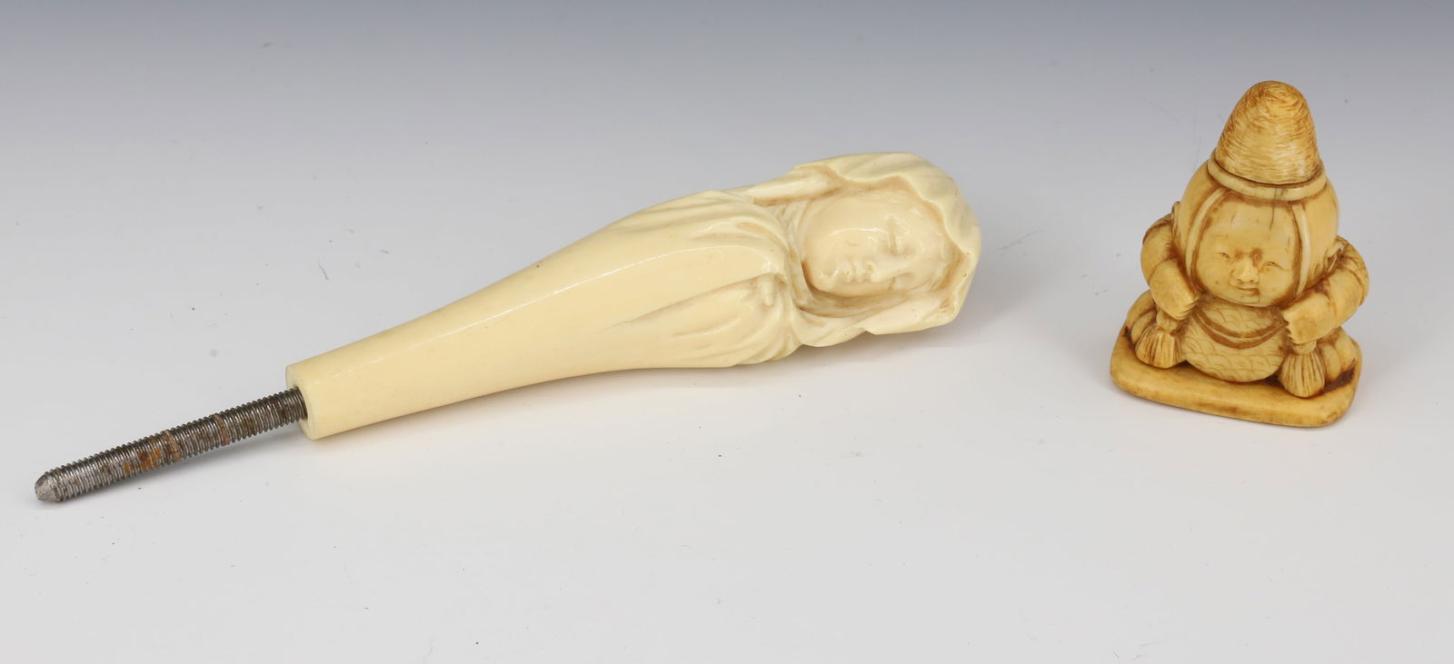 CARVED NETSUKE AND UMBRELLA HANDLE: CARVED KNEELING FIGURE (MRKD. ON BOTTOM) 2 1/4" H. CARVED BONE WOMAN WITH HEAD WRAP MRKD. J.W. FINCH. 5 1/8" (WITHOUT SCREW).