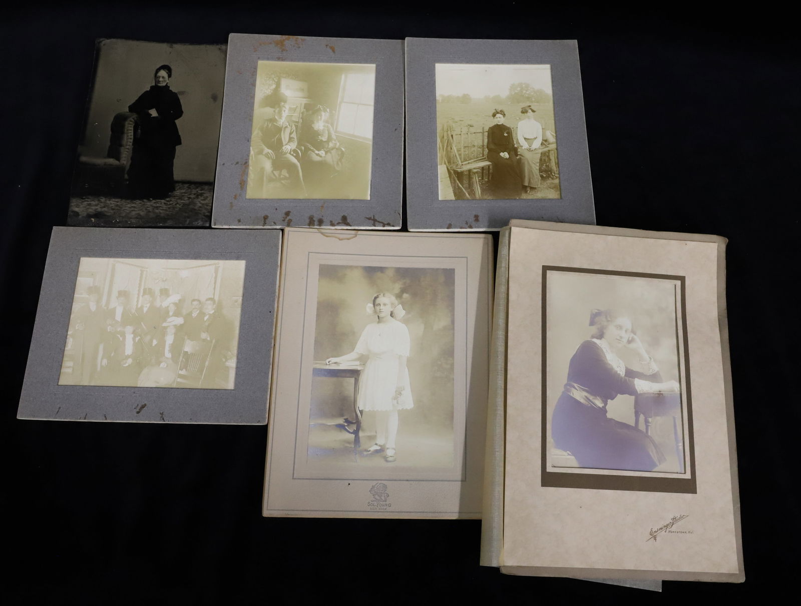 LARGE TINTYPE AND GROUP PHOTOGRAPHS: WOMAN IN BLACK W/ ARM ON CHAIR (TINTYPE 6 1/8" X 4"). VARIOUS GROUP AND SINGLE PHOTOGRAPHS.