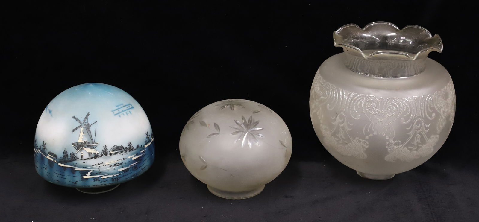 (3) VINTAGE LIGHT SHADES: PAINTED DUTCH SCENE IN BLUE/WHITE. 5 1/2" X 6" WITH 2 1/2" FITTER. FROSTED CUT TO CLEAR 4 3/4" X 6" WITH 3 1/8" FITTER. LARGEST HAS ART NOUVEAU PATTERN IN RELIEF. 8 1/4" H WITH 2 1/4" FITTER.