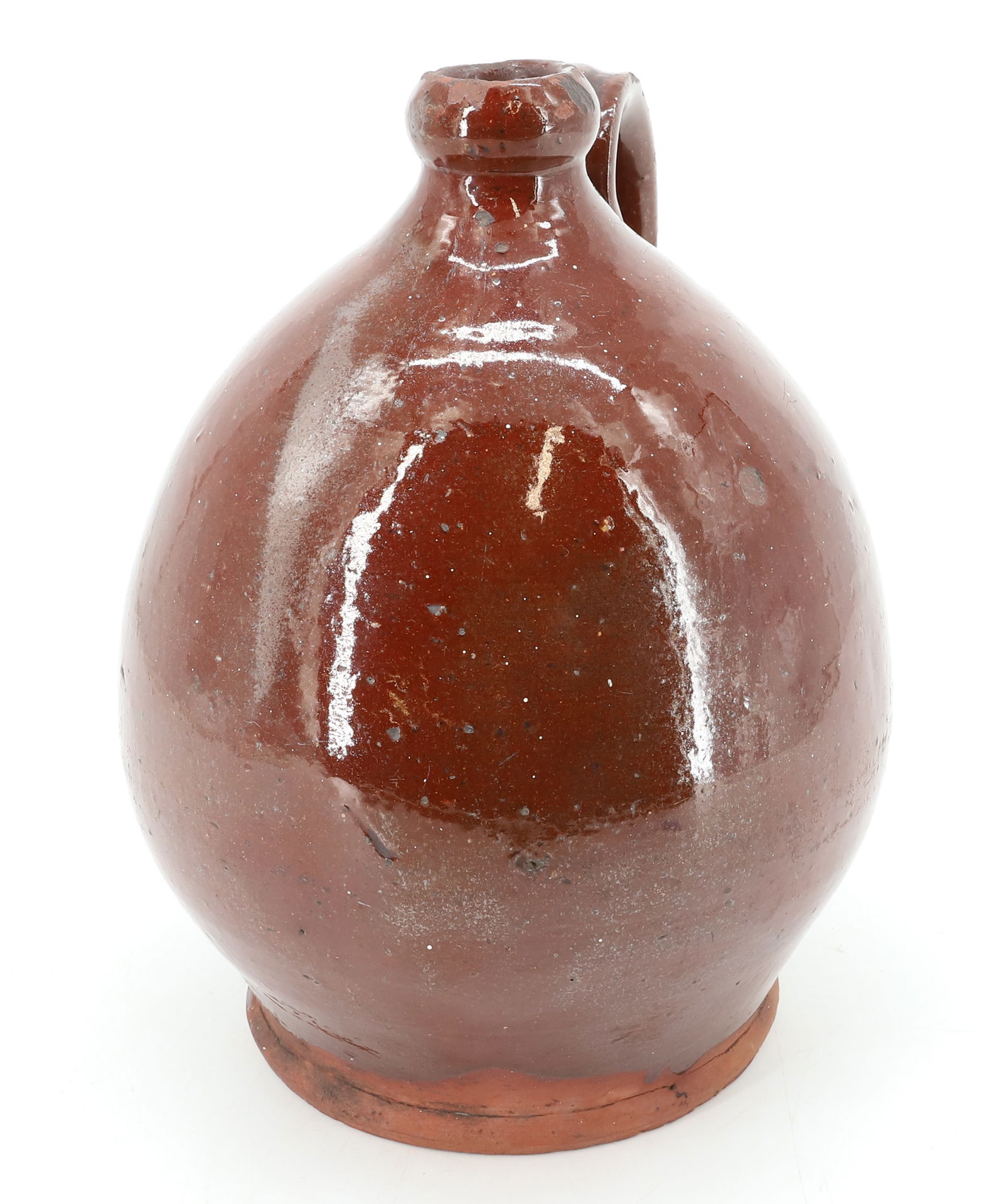 19TH C. REDWARE POTTERY JUG: OVOID SHAPE WITH BROWN/ORANGE GLAZE. APPLIED STRAP HANDLE. 9" H.