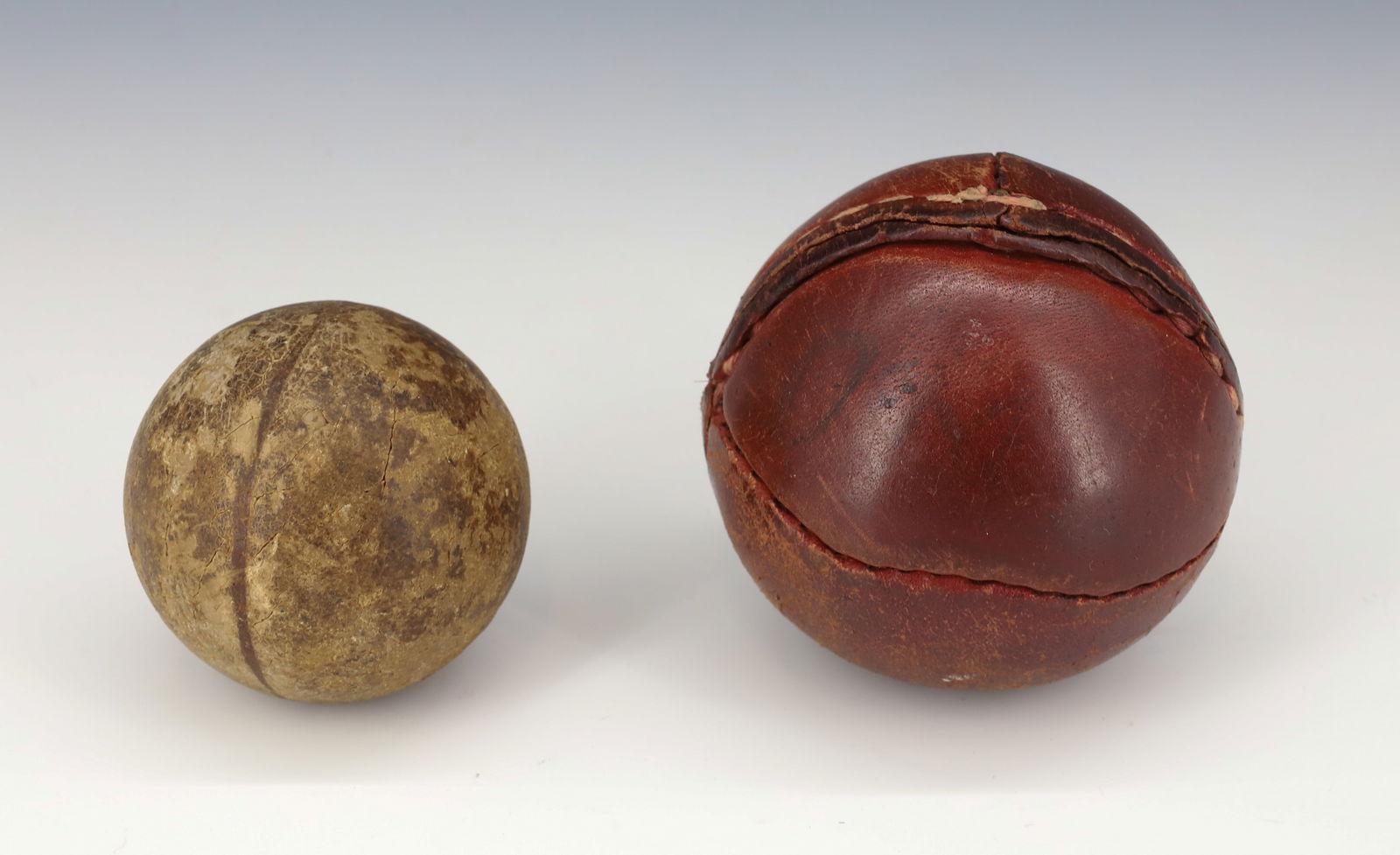 LOT OF ANTIQUE BALLS.: LEMON PEEL BASEBALL OR CRICKET BALL. 2 3/4" D. WITH, HEAVY DENSE BALL WITH LINE AROUND CENTER. 2" D.