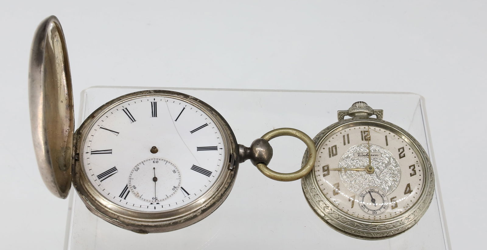 (2) POCKET WATCHES VANBUREN, NICHOLAS GOODWILL: ART DECO SILVEROID CASE VANBUREN ORNATE FACE WITH SECOND HAND SWISS MOVEMENT (15) JEWELS AND NICHOLAS GOODWILL NEW YORK KEY WIND WITH JEWELS SWISS MOVEMENT 2 1/4" X 1 3/4", 3 1/4" X 2 1/4" 