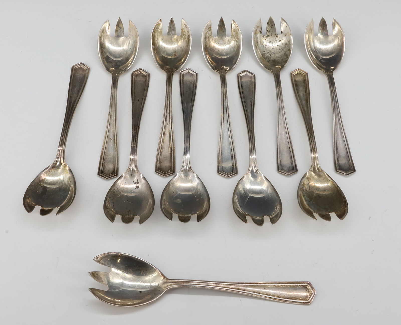 (11) STERLING SILVER ICE CREAM FORKS: 5 3/8" L TOTAL WEIGHT 7. OZT PLEASE READ CAREFULLY - SINCE THIS IS A JEWELRY AND COIN SALE PLEASE NOTE. ITEMS MUST BE PAID FOR THROUGH LIVE AUCTIONEERS OR WITH CASH OR CHECK IN PERSON - Terms