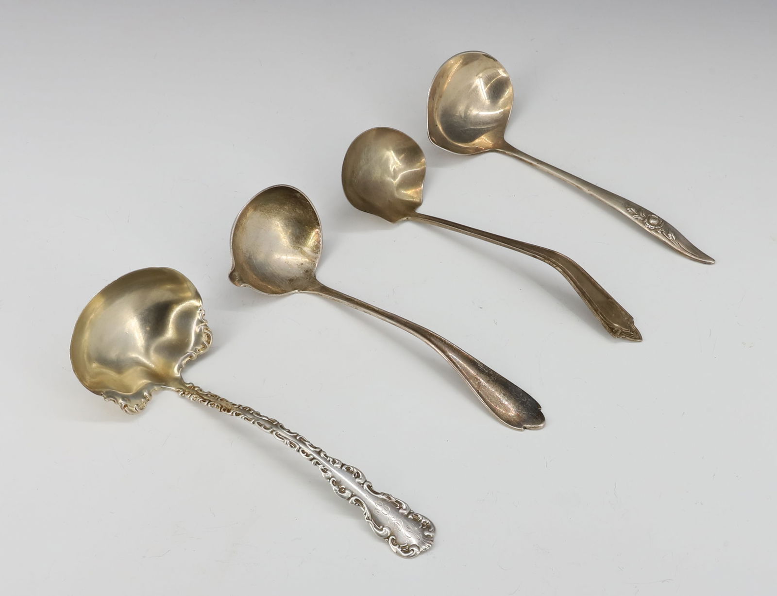 (4) STERLING SILVER SAUCE LADLES: DIFFERENT MANUFACTURERS 5 1/4",5 1/2"L TOTAL WEIGHT 3.1 OZT PLEASE READ CAREFULLY - SINCE THIS IS A JEWELRY AND COIN SALE PLEASE NOTE. ITEMS MUST BE PAID FOR THROUGH LIVE AUCTIONEERS OR WITH CASH
