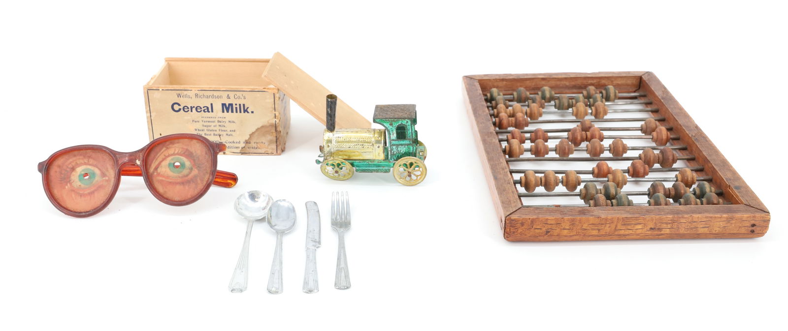 ABACUS, TIN TOY, MINIATURE FLATWARE: WOOD / METAL ABACUS. COLORED BEADS 6 1/2" X 9 7/8". SERVICE FOR (6) MINIATURE FLATWARE IN SLIDE LID ADVERTISING BOX. PRESSED METAL LOCOMOTIVE 3 1/8" L. PLASTIC TOY EYEGLASSES. PLEASE READ
